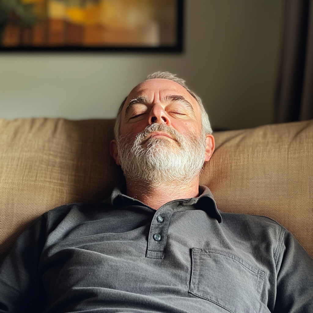 A man sleeping on a couch | Source: Midjourney