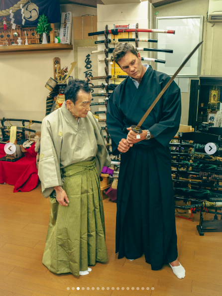 Tom Brady wielding a sword with someone standing next to him. | Source: Instagram/tombrady
