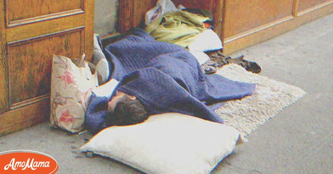 A homeless man sleeping on the street | Source: Shutterstock