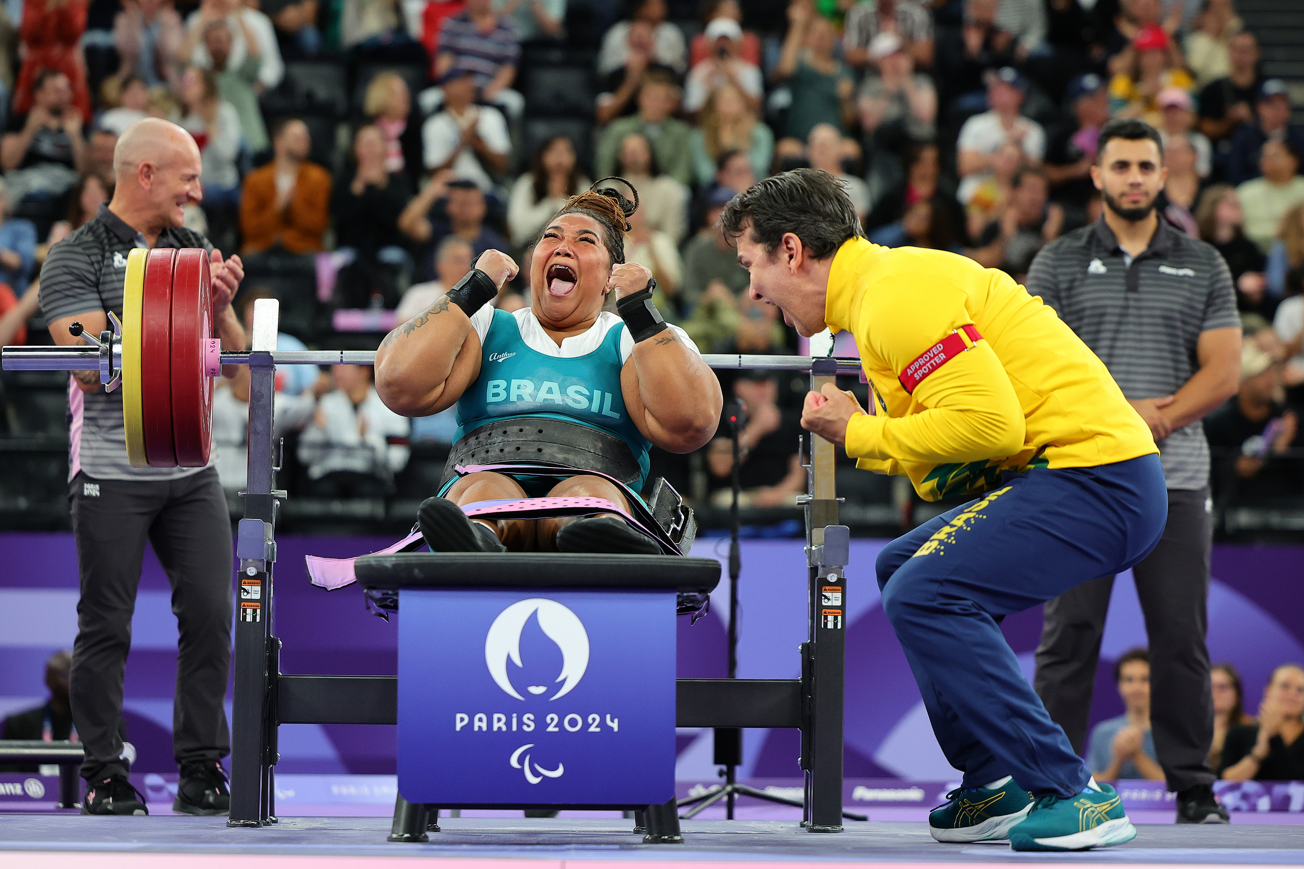 Tayana Medeiros of Team Brazil celebrates taking the Gold Medal with her spotter during the Women's up to 86kg Final on day eleven of the Paris 2024 Summer Paralympic Games at Porte de La Chapelle Arena on September 8, 2024, in Paris, France | Source: Getty Images