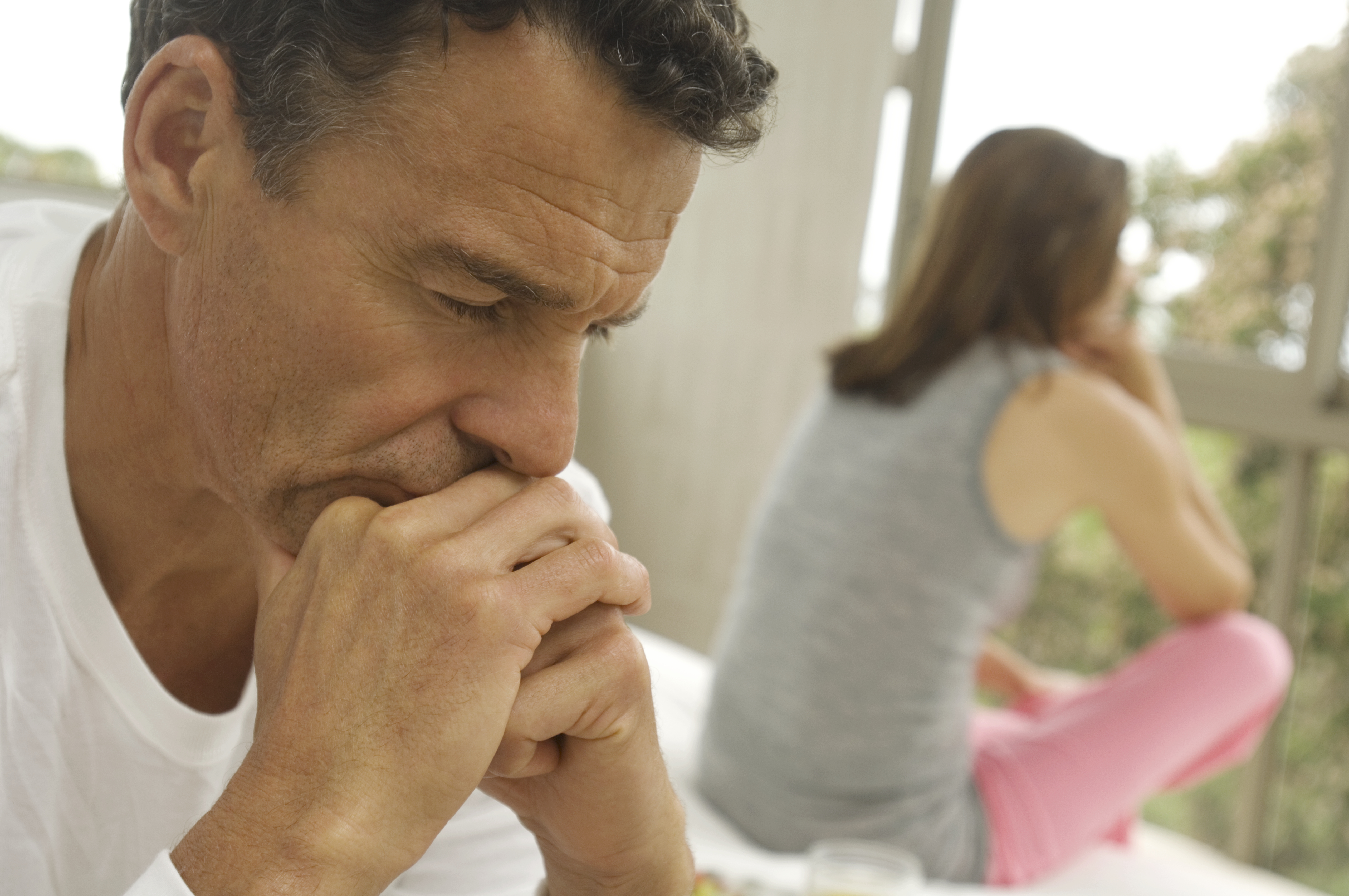 A couple sitting apart after an argument | Source: Getty Images