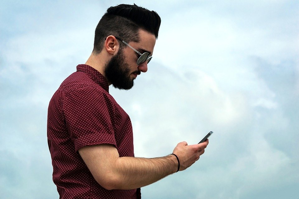 A man using his phone. | Photo: Pixabay
