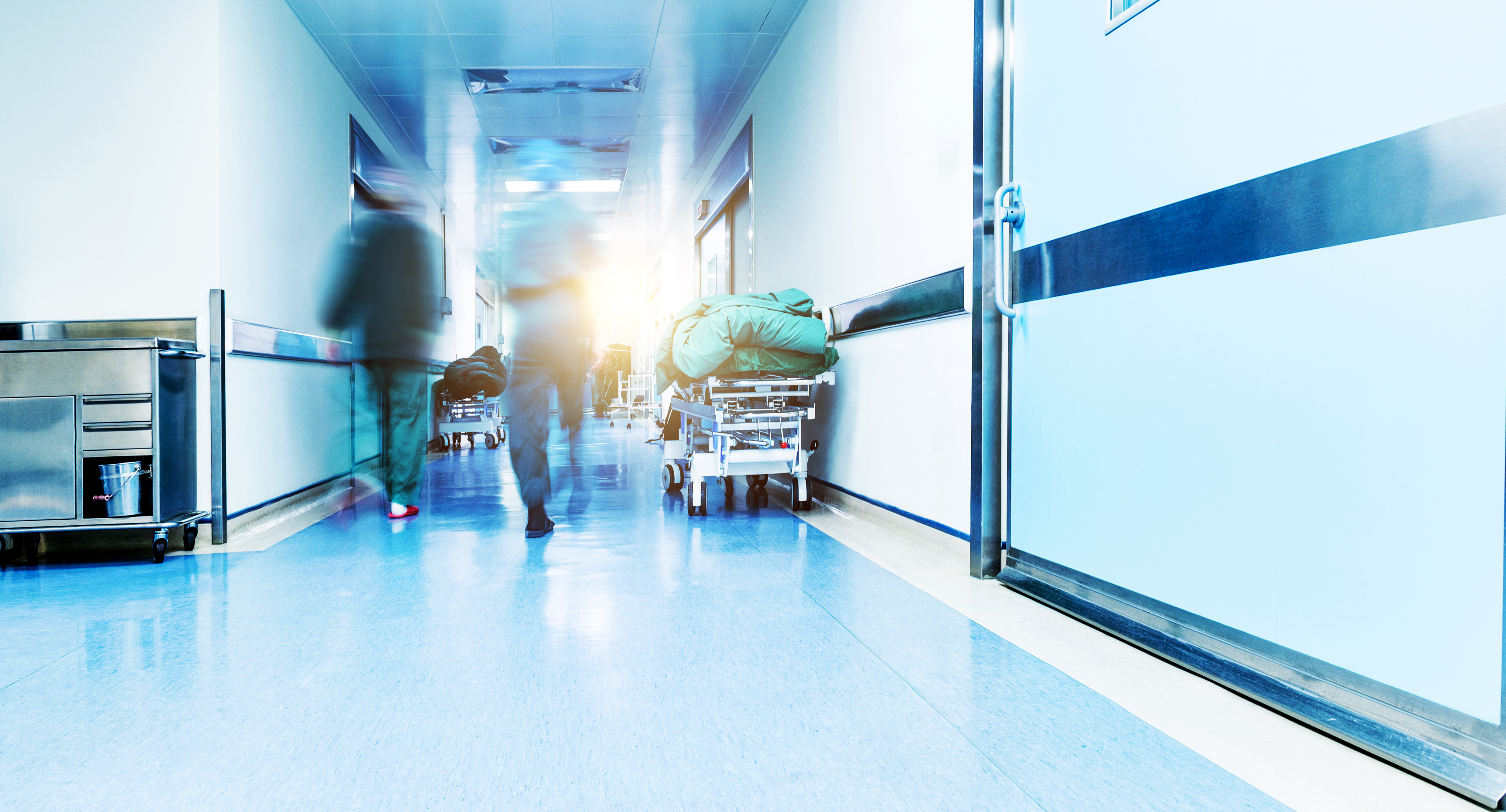 Doctors or nurses walking in hospital hallway, blurred motion | Source: Shutterstock