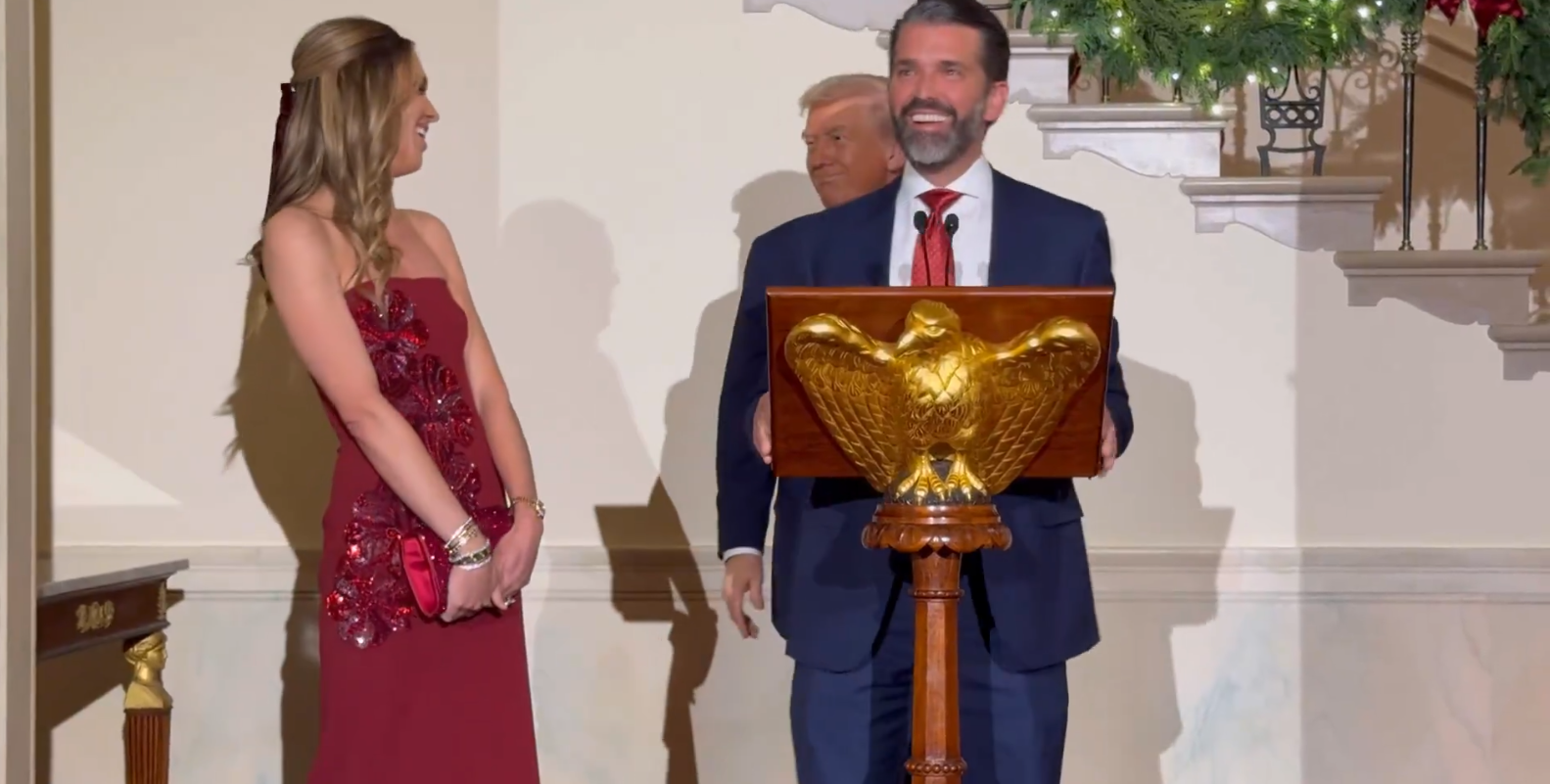 Donald Trump Jr. and his fiancée Bettina Anderson and President Donald Trump at the White House holiday event on December 15, 2025 | Source: X/LauraLoomer