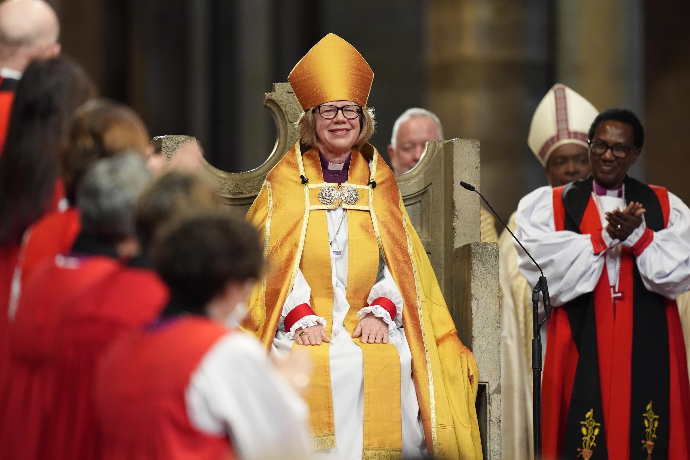 Hands resting calmly in her lap, Mullally sat in the ancient marble seat of St. Augustine's Chair on 25 March 2026 — the first woman in nearly fifteen hundred years of history to occupy it — as the clergy gathered around her broke into applause, the sound of it rising through the full length of Canterbury Cathedral.