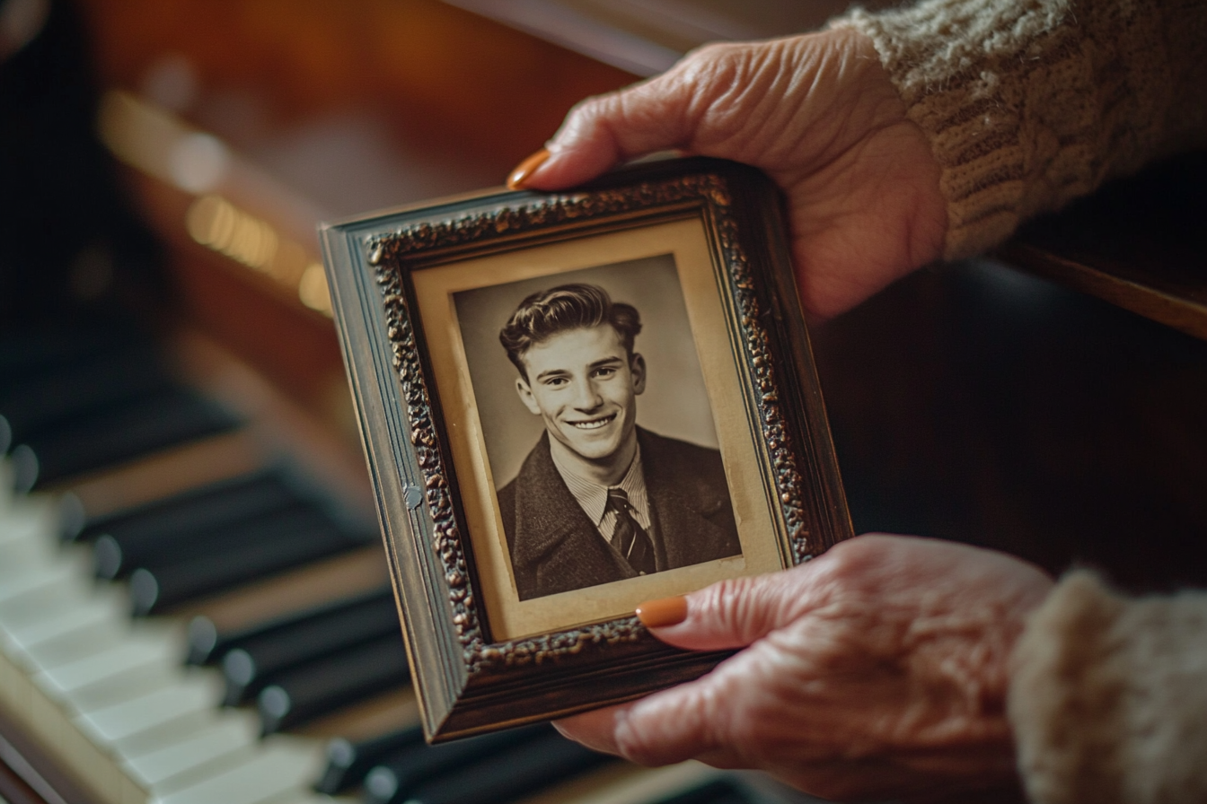 Close-up of an older lady holding a framed photo of a man | Source: Midjourney