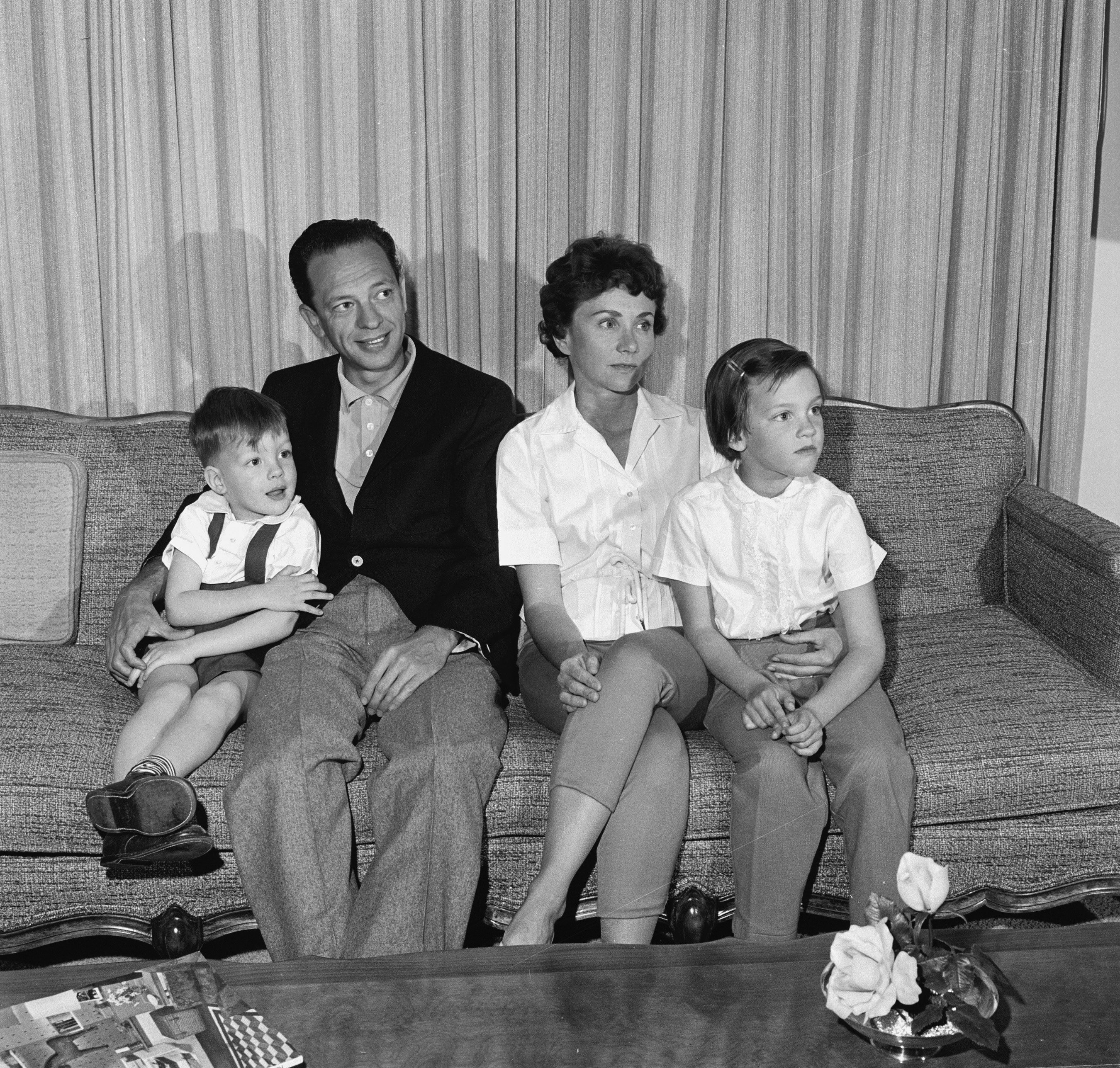 American television actor Don Knotts (second left) sits on a couch with his family at home, March 2, 1961. | Source: Getty Images