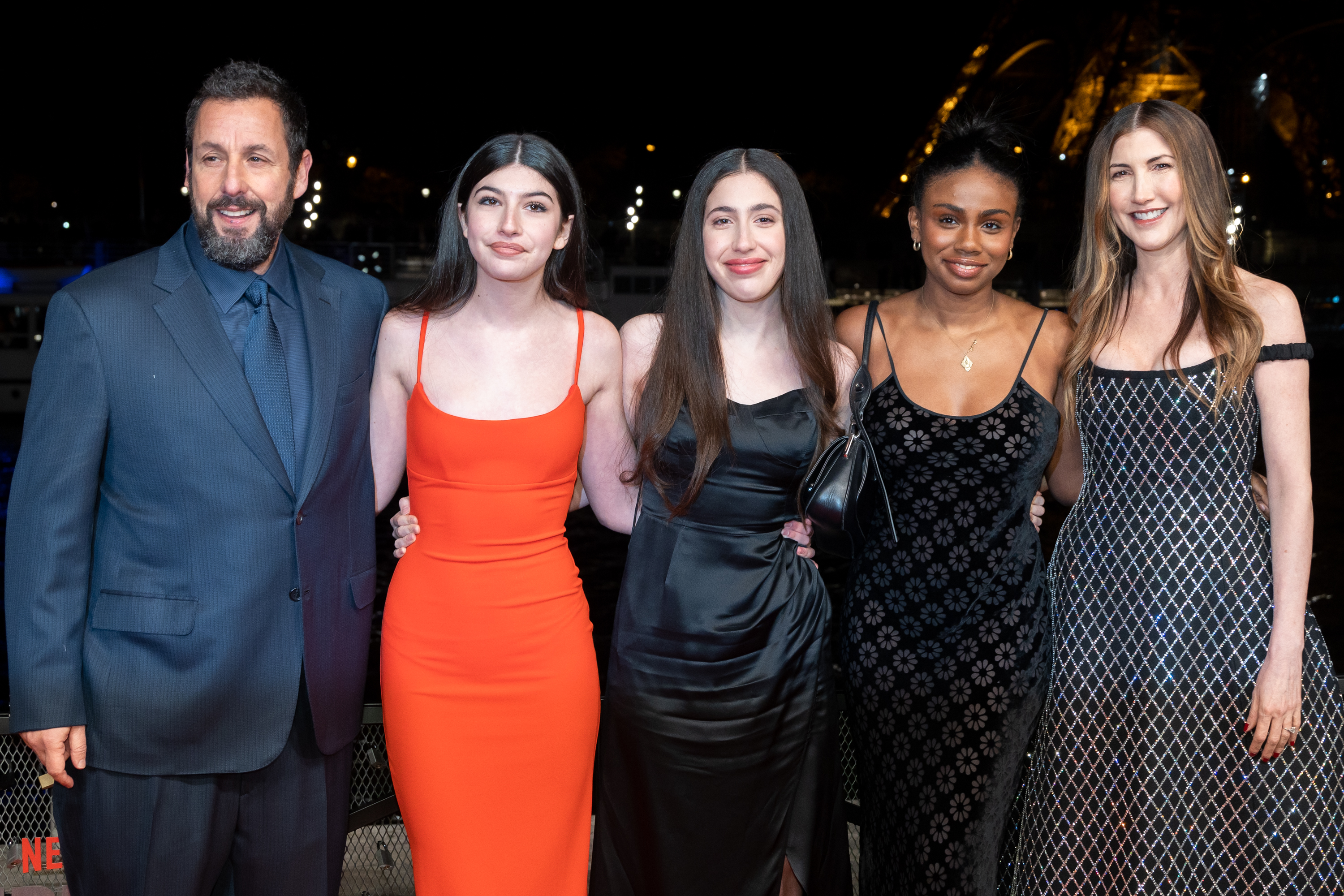 Now outside their home country, Adam, Jackie, Sadie, Sunny Sandler, and a guest brought their A-game to Paris. Attending the "Murder Mystery 2" photocall at Pont Debilly, the ladies stunned in exquisite, colorful dresses that perfectly complemented Adam’s classic suit.