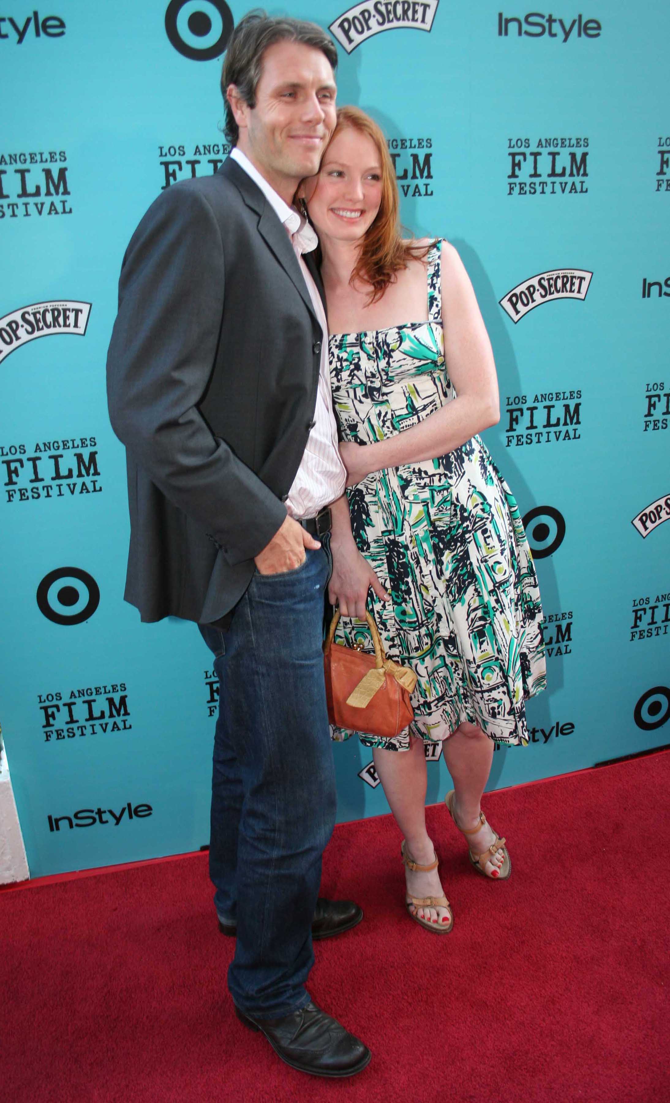 Nathan Folger and Alicia Witt pose on the red carpet at the "Nine Lives" Premiere during the Los Angeles Film Festival at Academy of Motion Pictures and Sciences on June 21, 2005 | Source: Getty Images