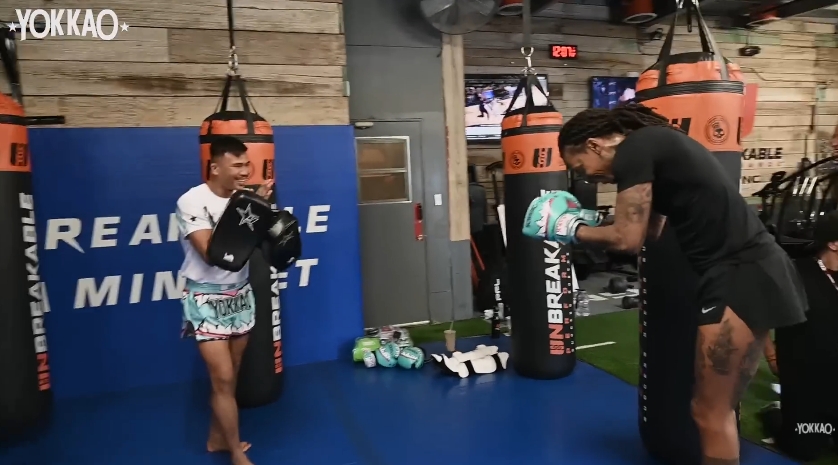 Superlek Kiatmoo9 and Wiz Khalifa share a laugh between drills at the conclusion of their session. | Source: YouTube/YOKKAO