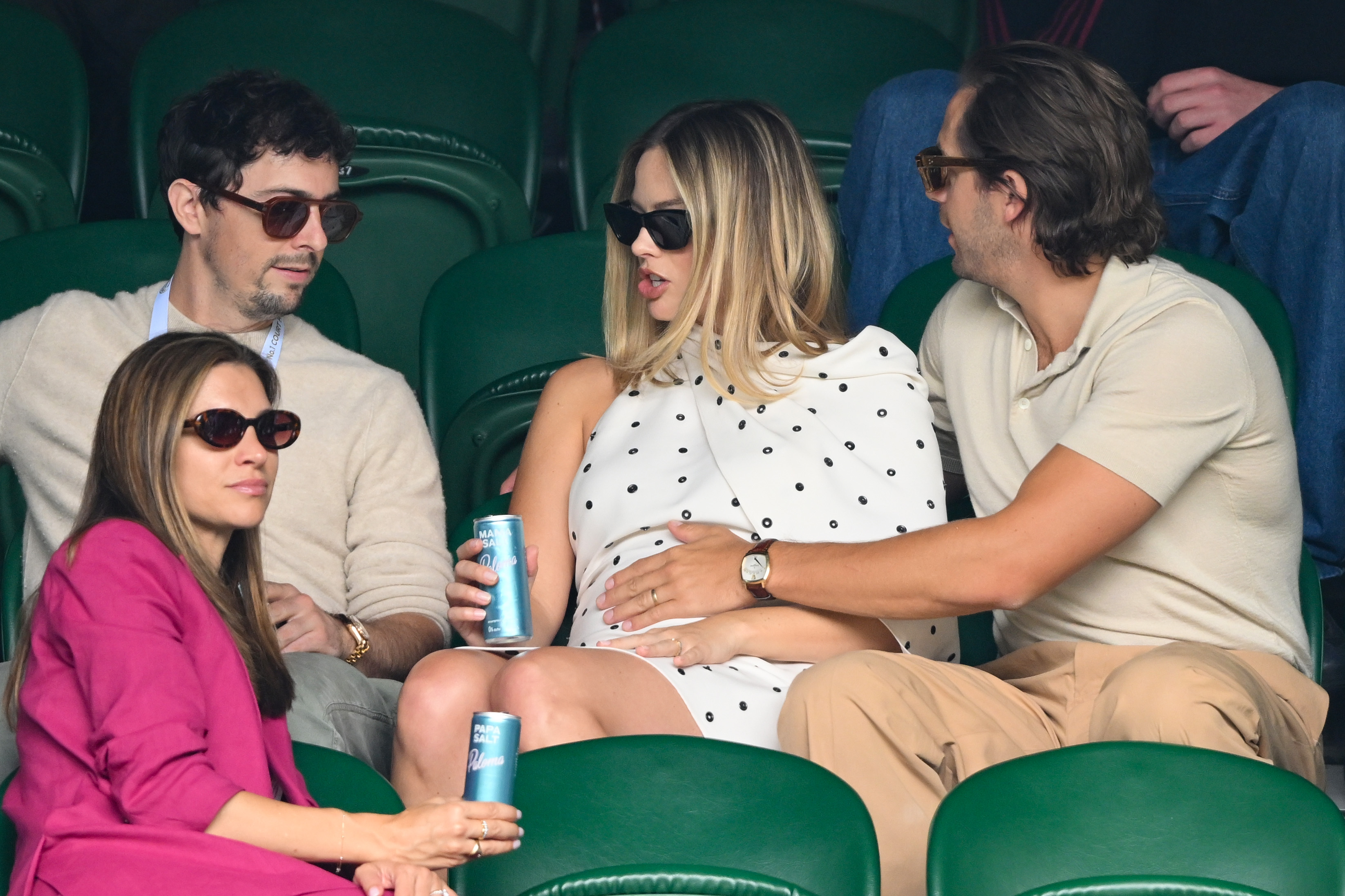 Josey McNamara, Margot Robbie, and Tom Ackerley court-side of Centre Court on day twelve of the Wimbledon Tennis Championships in London, England, on July 12, 2024 | Source: Getty Images