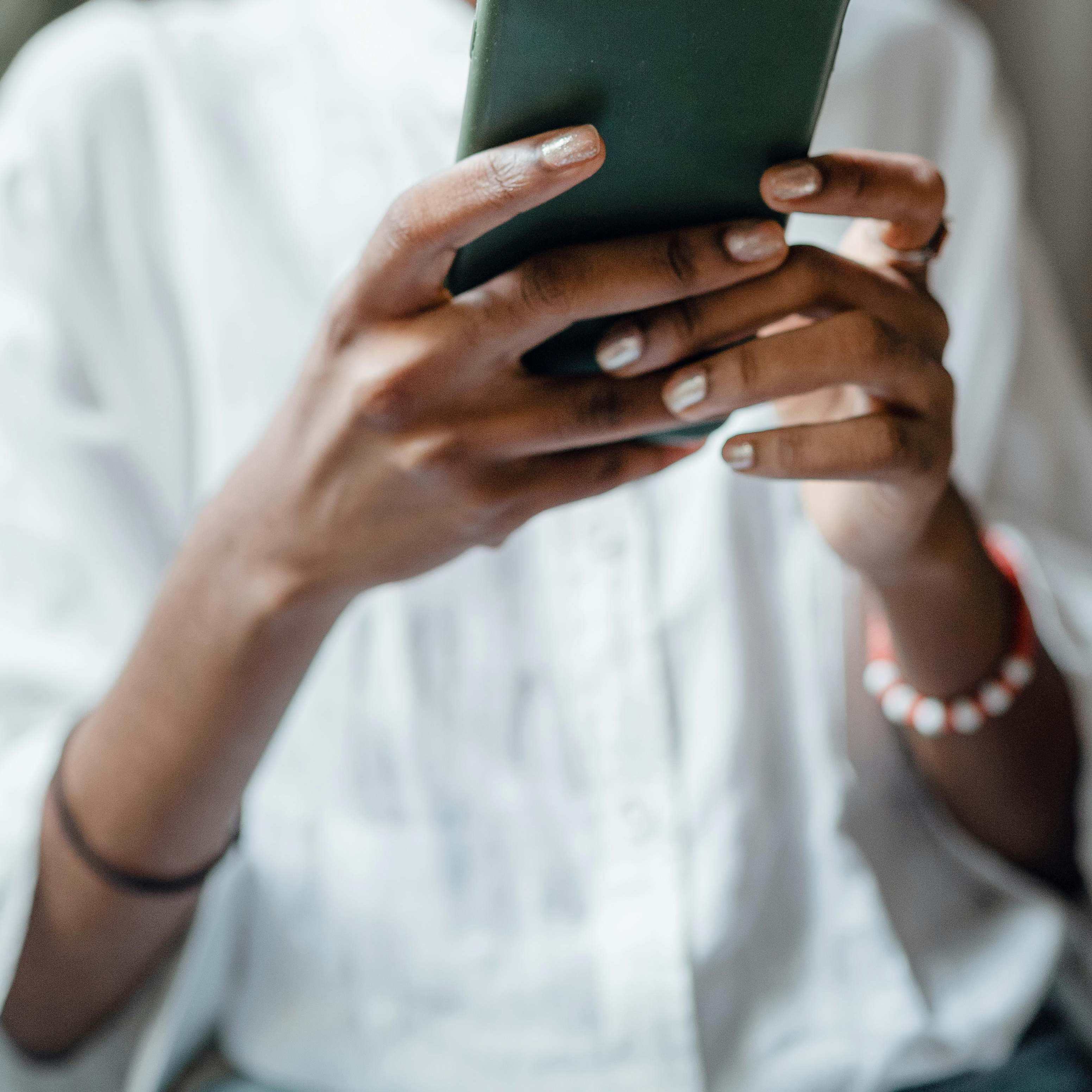 A woman taking up a mobile phone | Source: Pexels