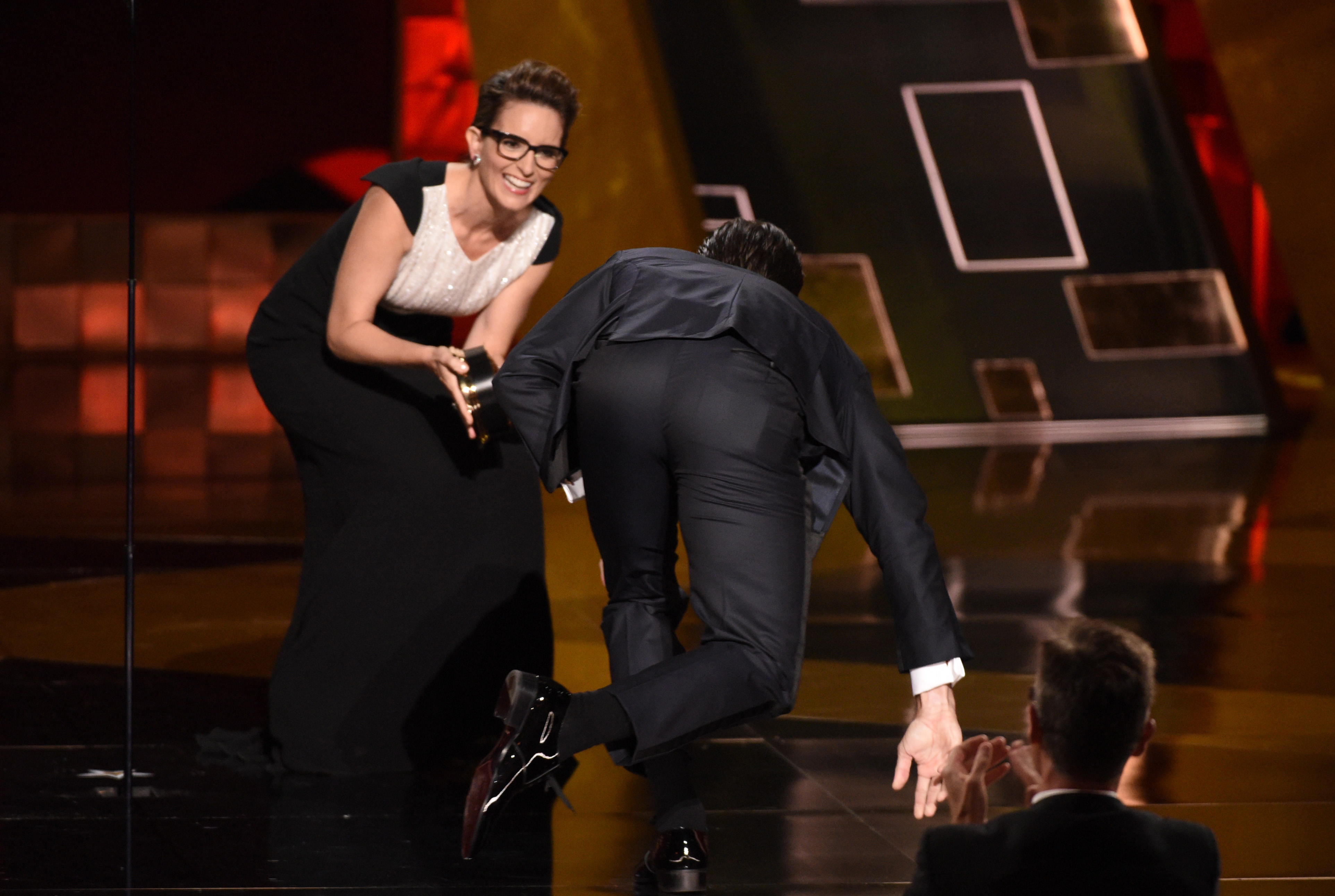 Jon Hamm climbing onstage to accept the Outstanding Lead Actor in a Drama Series award for "Mad Men" during the 67th Annual Primetime Emmy Awards on September 20, 2015, in Los Angeles, California. | Source: Getty Images