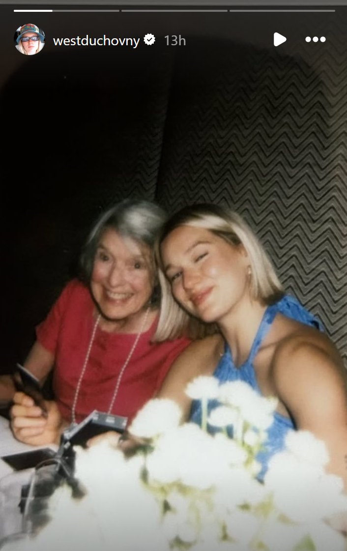 A guest and West Duchovny sitting together at a table Tim Daly and Téa Leoni's intimate wedding, dated July 14, 2025 | Source: Instagram/westduchovny