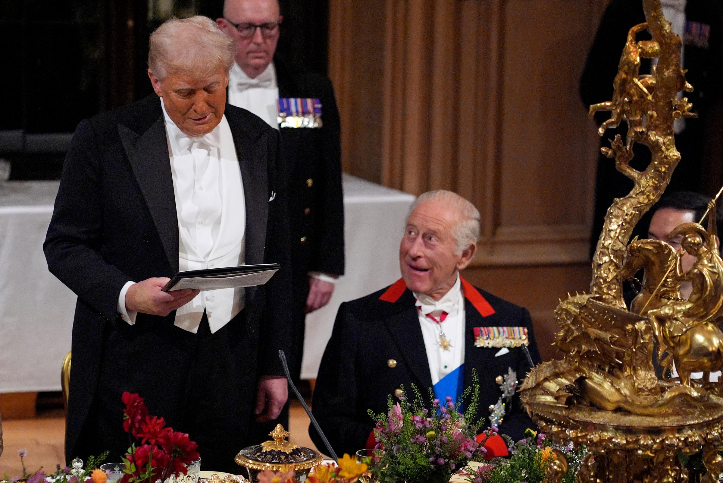 Donald Trump delivering remarks during dinner as King Charles III looks on. | Source: Getty Images