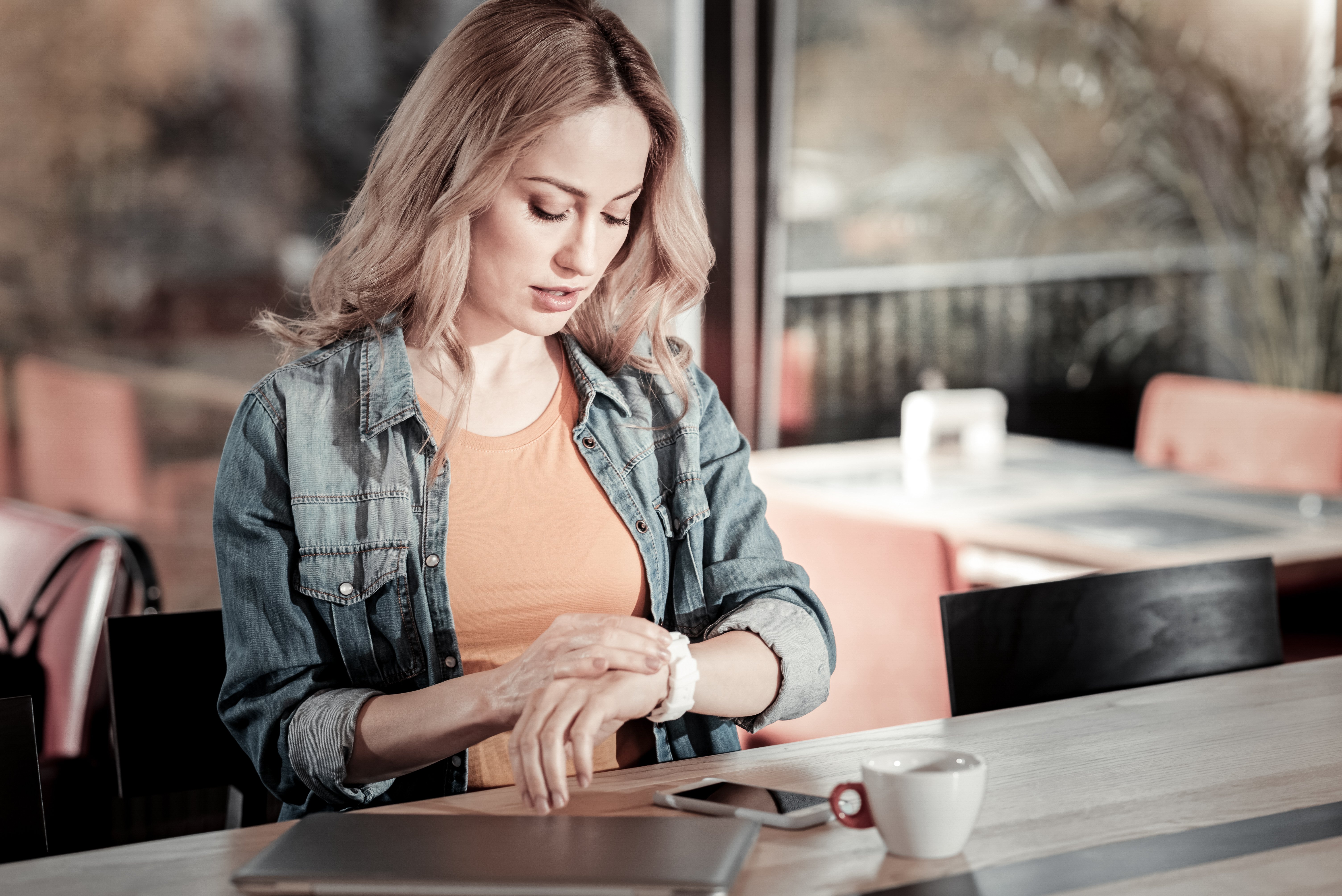 Woman looking at her watch. Image credit: Shutterstock