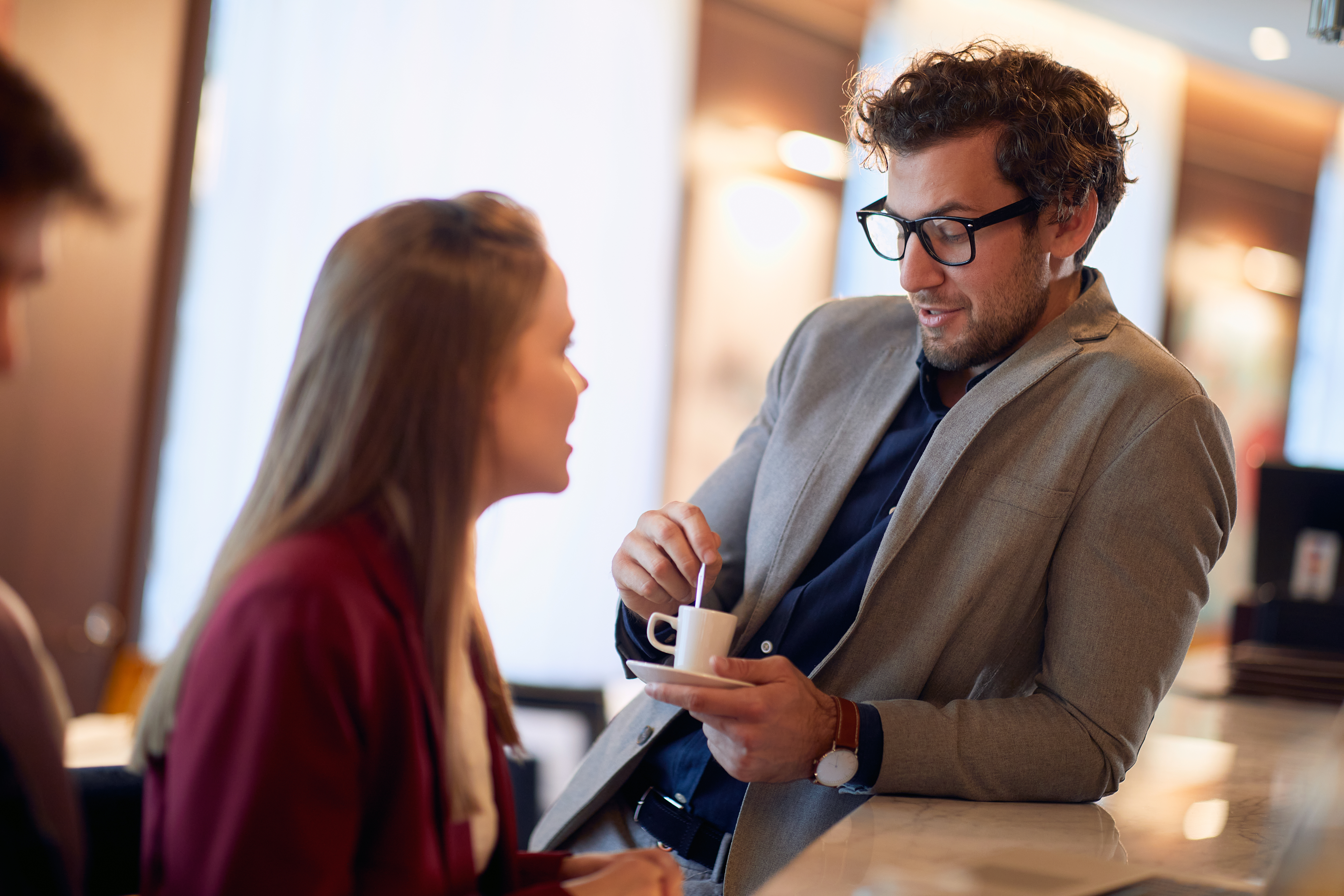 Businessman speaks with young woman. | Source: Shutterstock