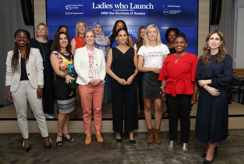 Meghan poses with 12 inspiring female entrepreneurs as she visits Woodstock Exchange. | Source: Getty Images