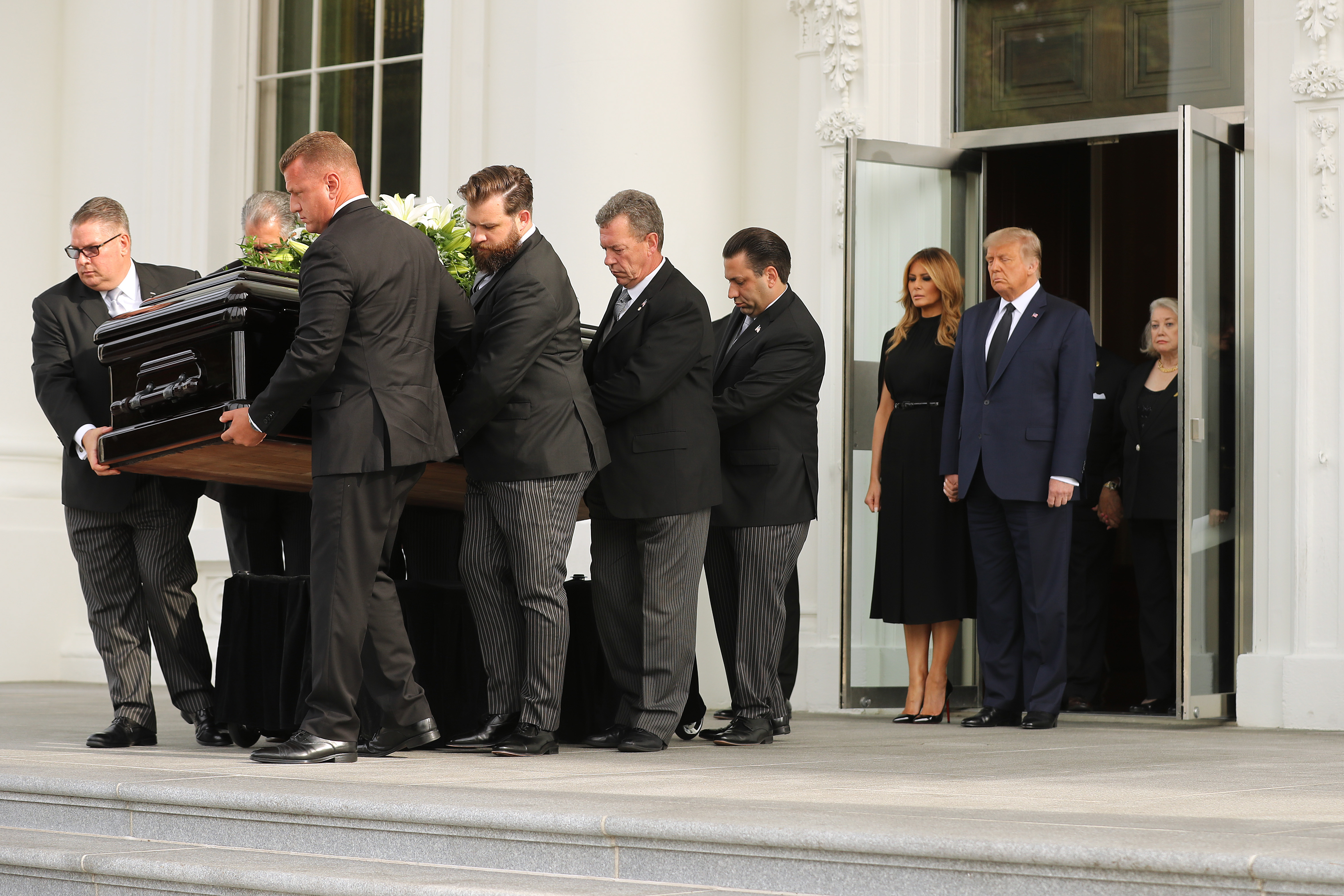 President Donald Trump and First Lady Melania Trump follow Robert Trump's casket out of the White House following his funeral service on August 21, 2020 | Source: Getty Images