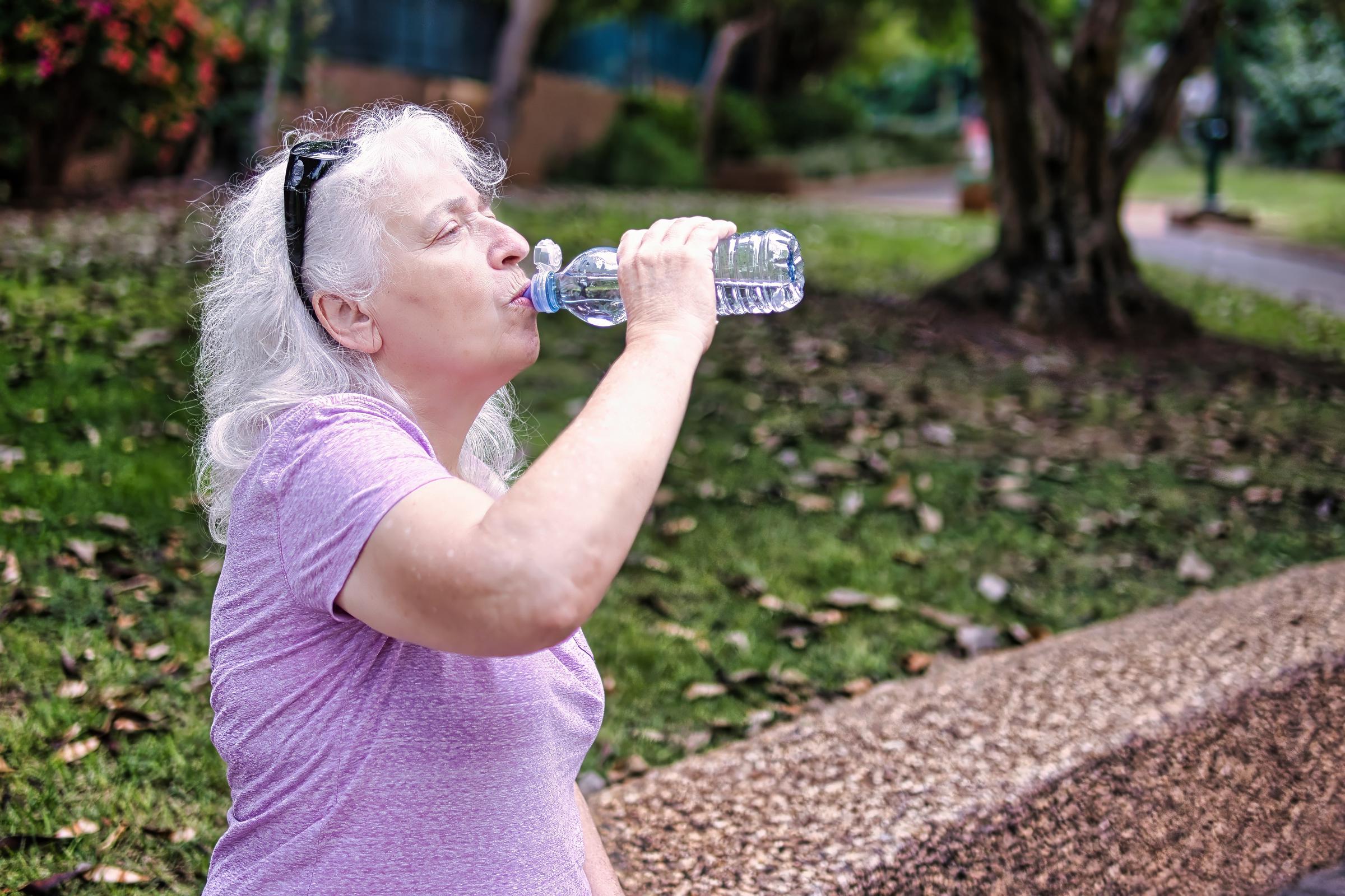 Woman drinking water from a bottle | Source: Shutterstock