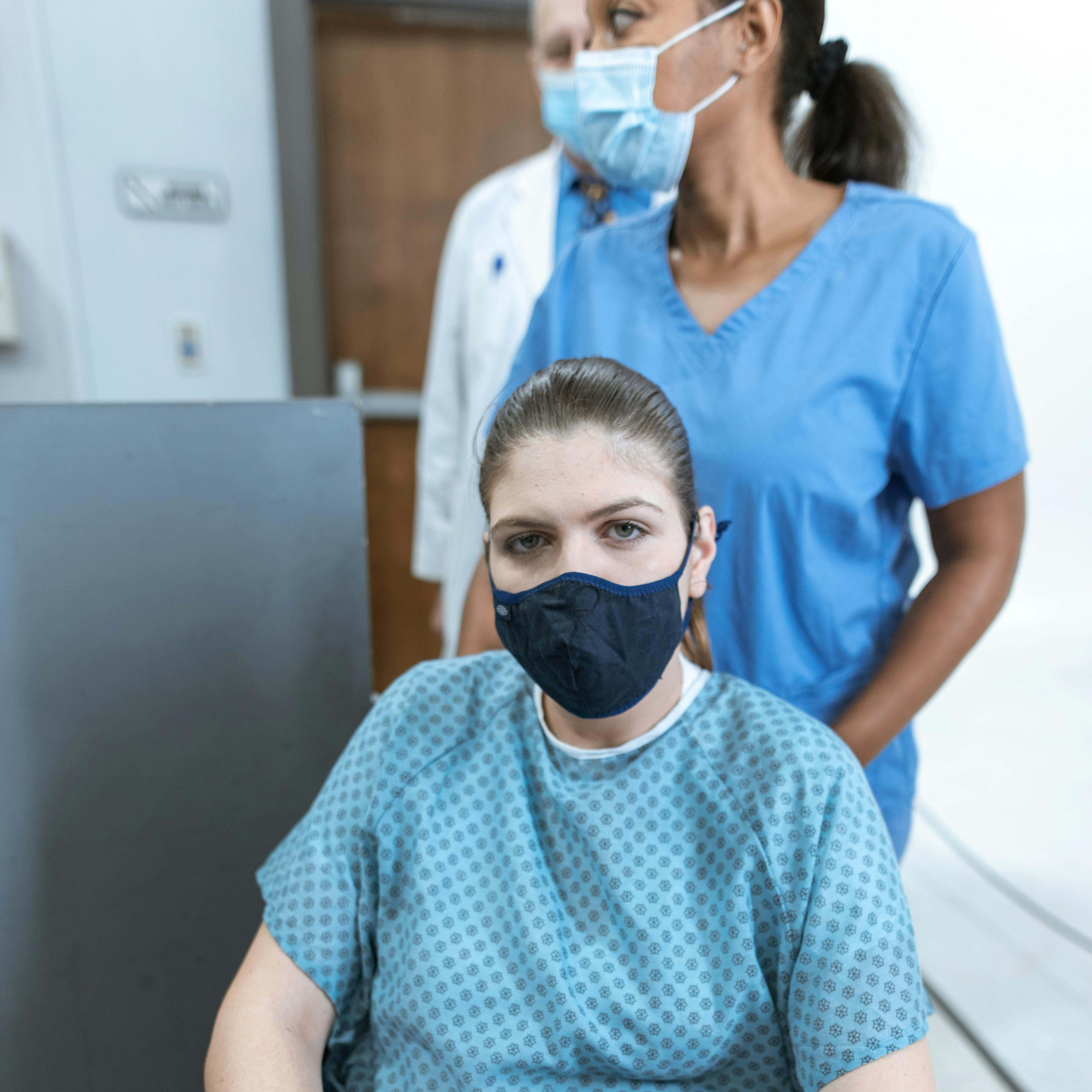 A nurse wheeling a patient through a hospital hallway | Source: Pexels