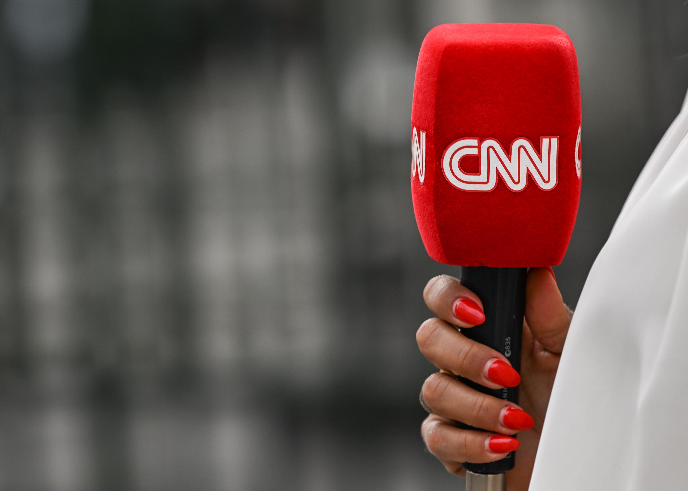 A reporter holding a CNN microphone in Paris, France on July 8, 2024. | Source: Getty Images