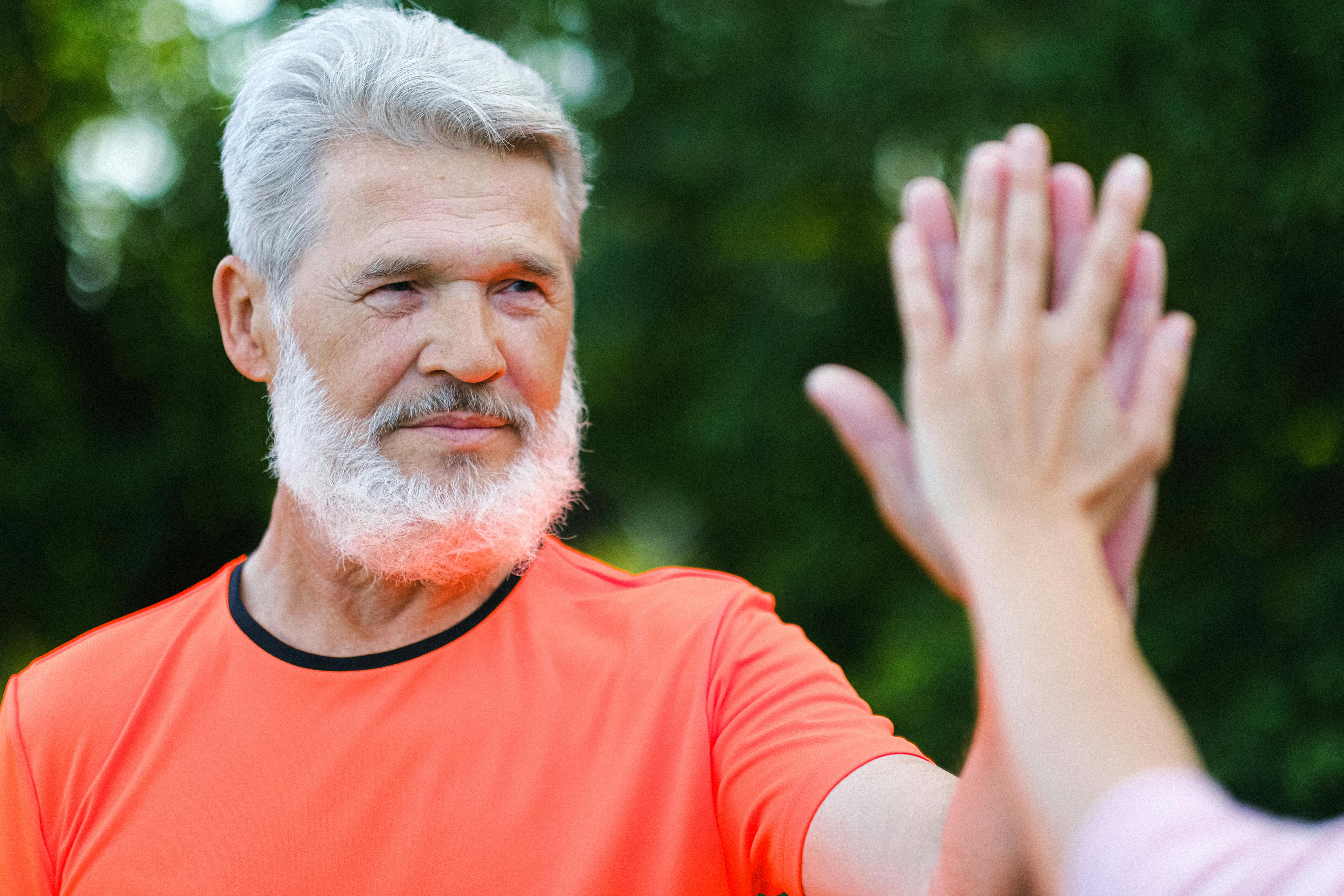 A man giving a high-five to someone off-camera | Source: Pexels