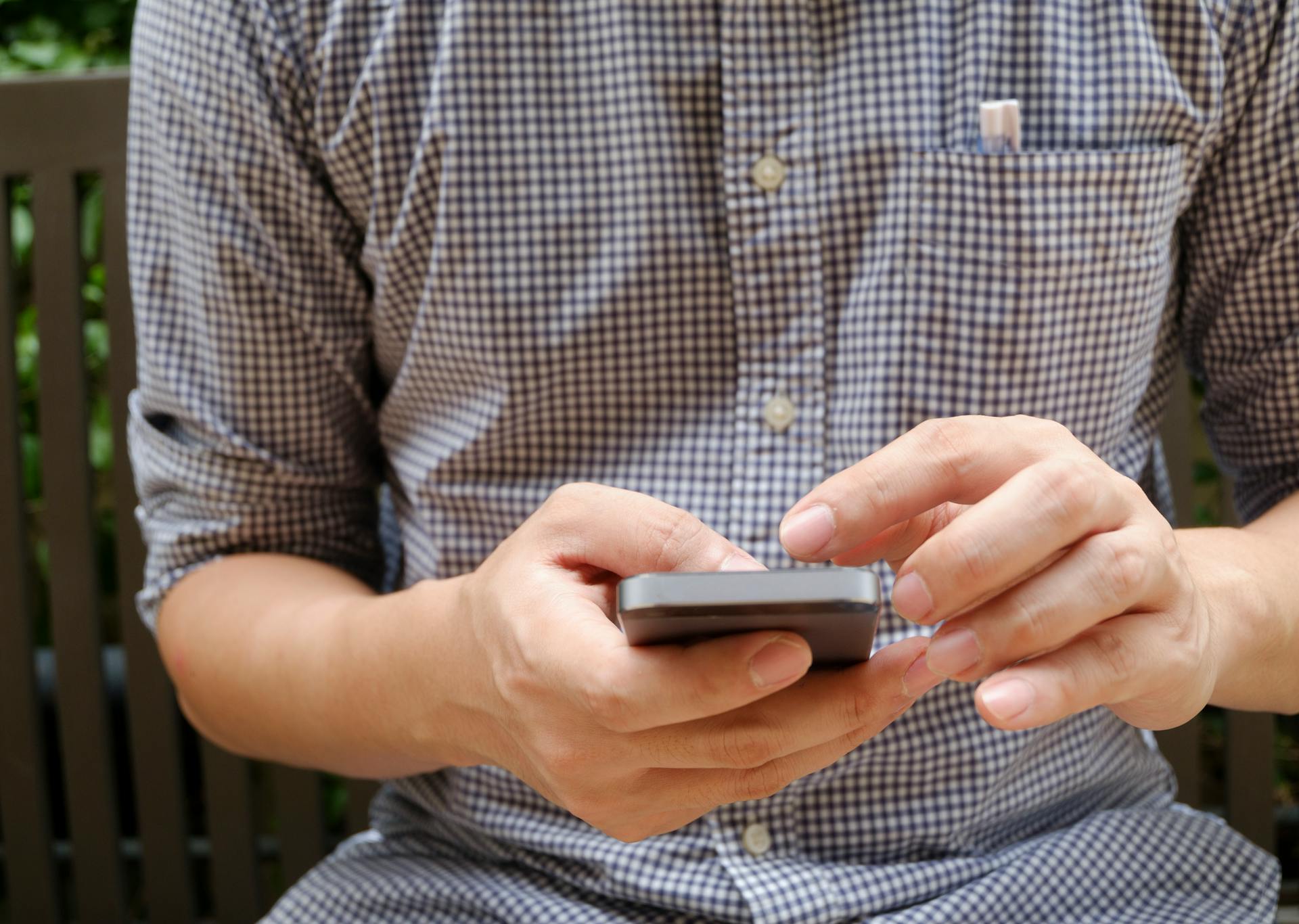 A man checking his phone notifications | Source: Pexels