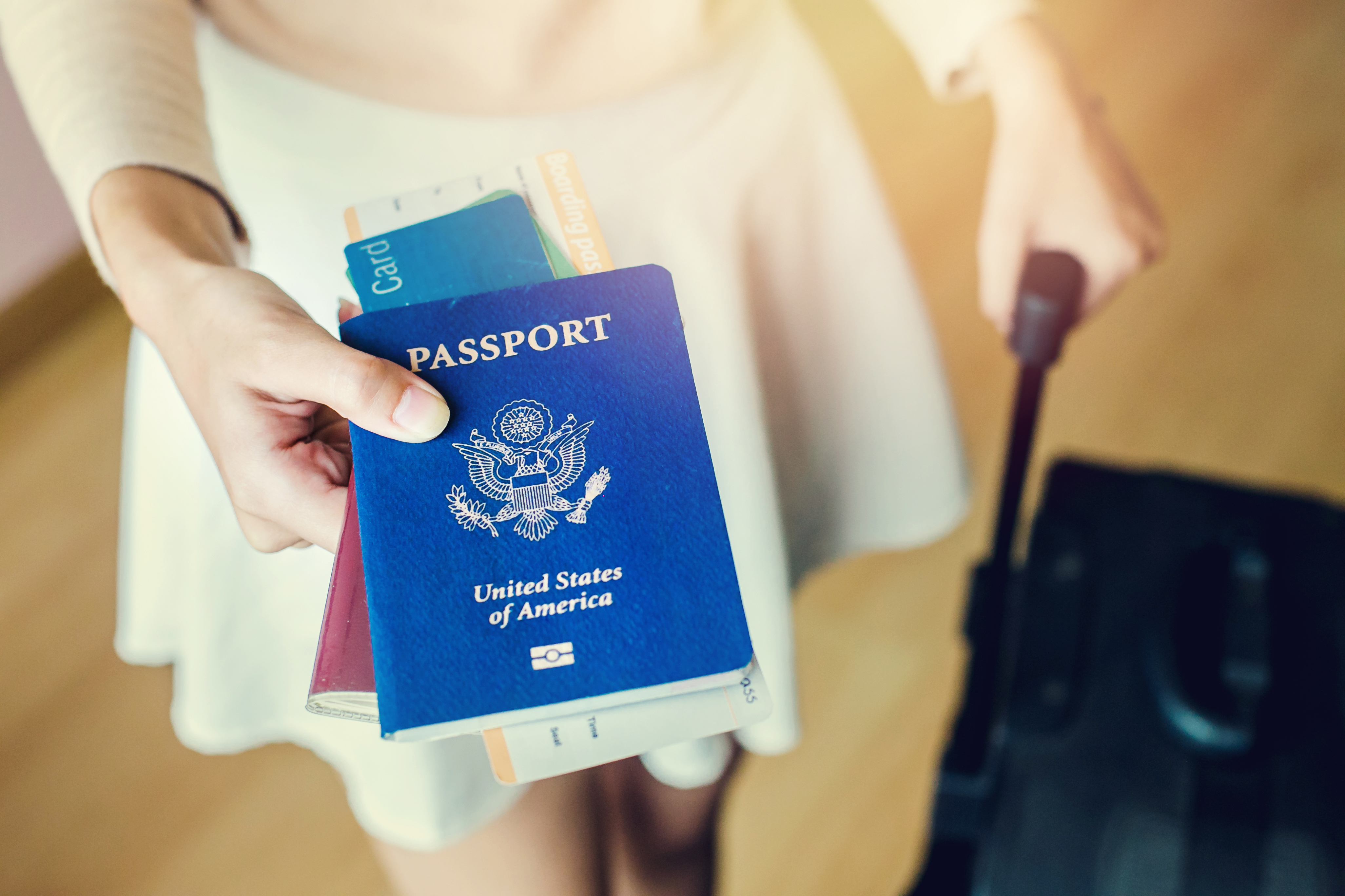 Girl holding passports and boarding pass | Source: Shutterstock