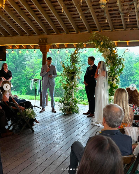Ian Hock and Eva Amurri standing at the alter, listening to a guest's speech, posted on July 1, 2024 | Source: Instagram/marcus.mcgregor