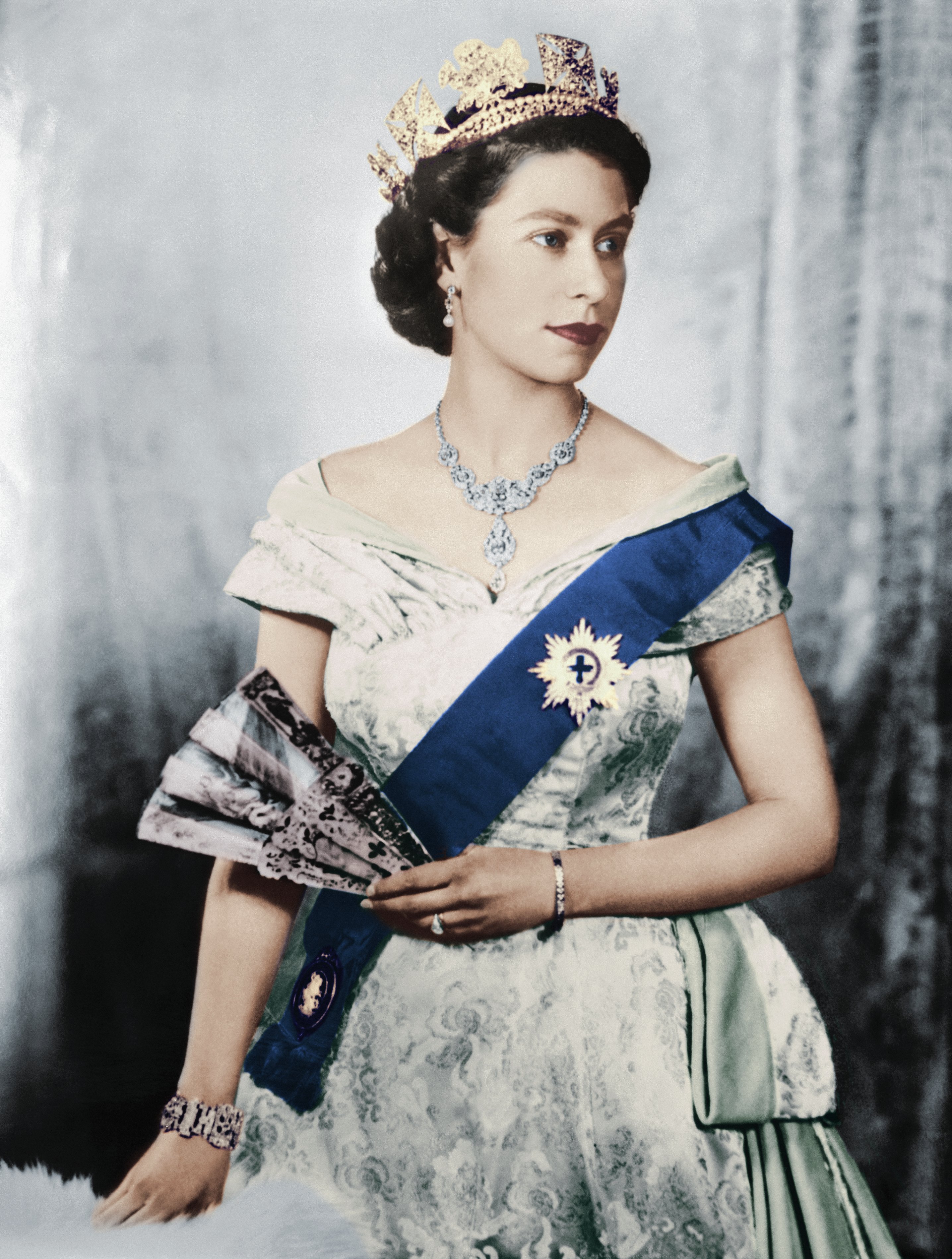 A portrait of young Queen Elizabeth II of England donning regal attire paired with a tiara. / Source: Getty Images