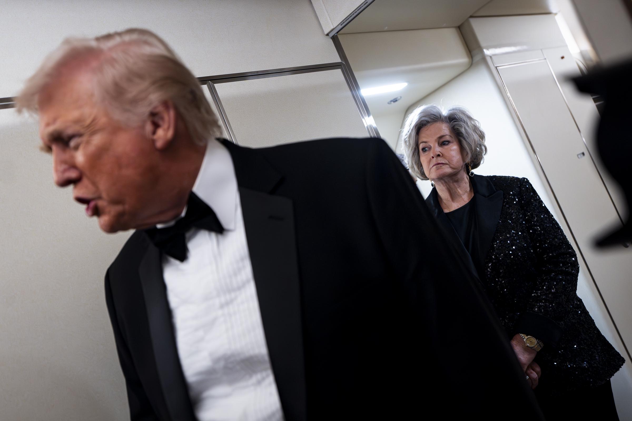Susie Wiles listens as Donald Trump speaks to reporters and members of the media on board Air Force One on January 31, 2026 | Source: Getty Images