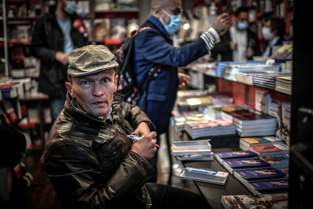 French author Sylvain Tesson poses inside the Librairie des Abbesses in the Montmartre district as he signs one of his books at the launch of the event 