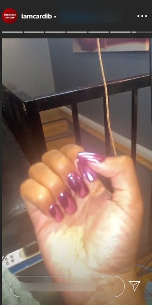 Cardi B showing off her purple nails | Photo: Instagram/iamcardib