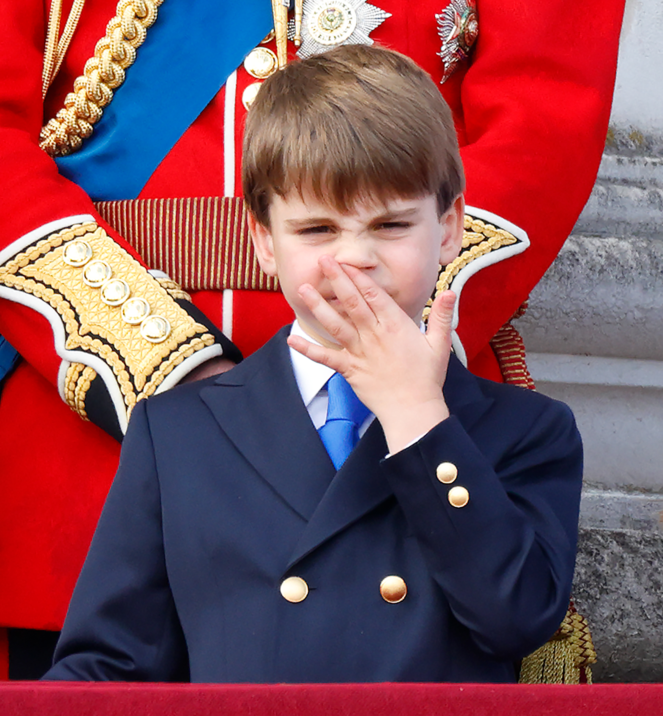 Prince Louis seemingly picks his nose as he watches the Royal Air Force flypast from Buckingham Palace's balcony after Trooping the Colour in London on June 15, 2024. | Source: Getty Images