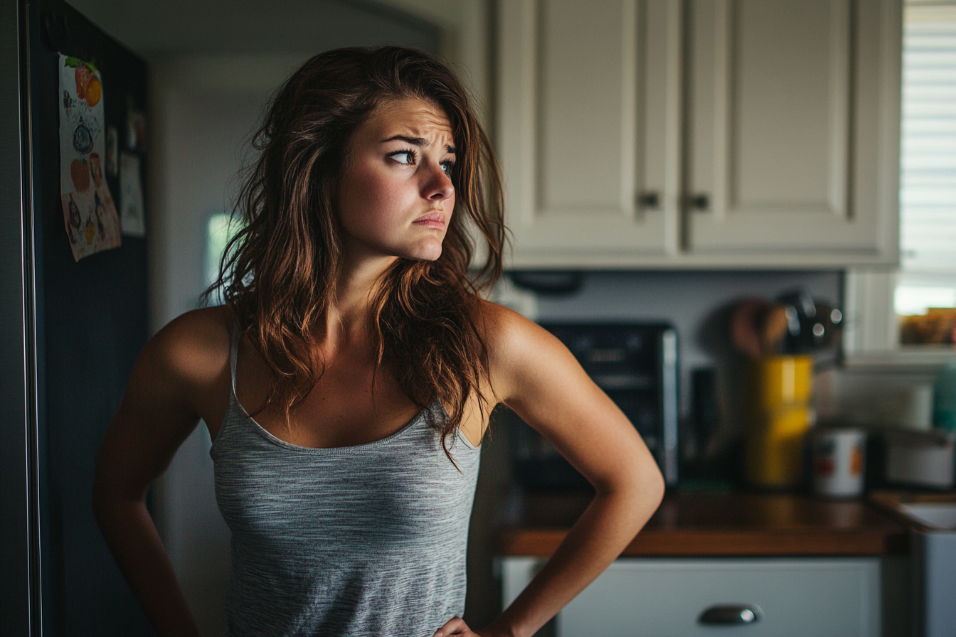 A concerned woman in a kitchen | Source: Midjourney