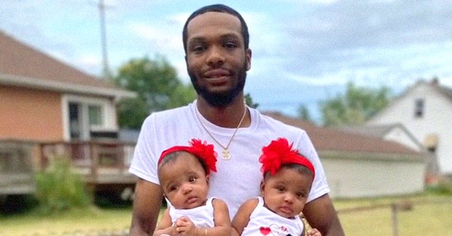 Ray Lucas holding his two 18-month-old girl twins Milan and Malaysia. │ Source: twitter.com/washingtonpost