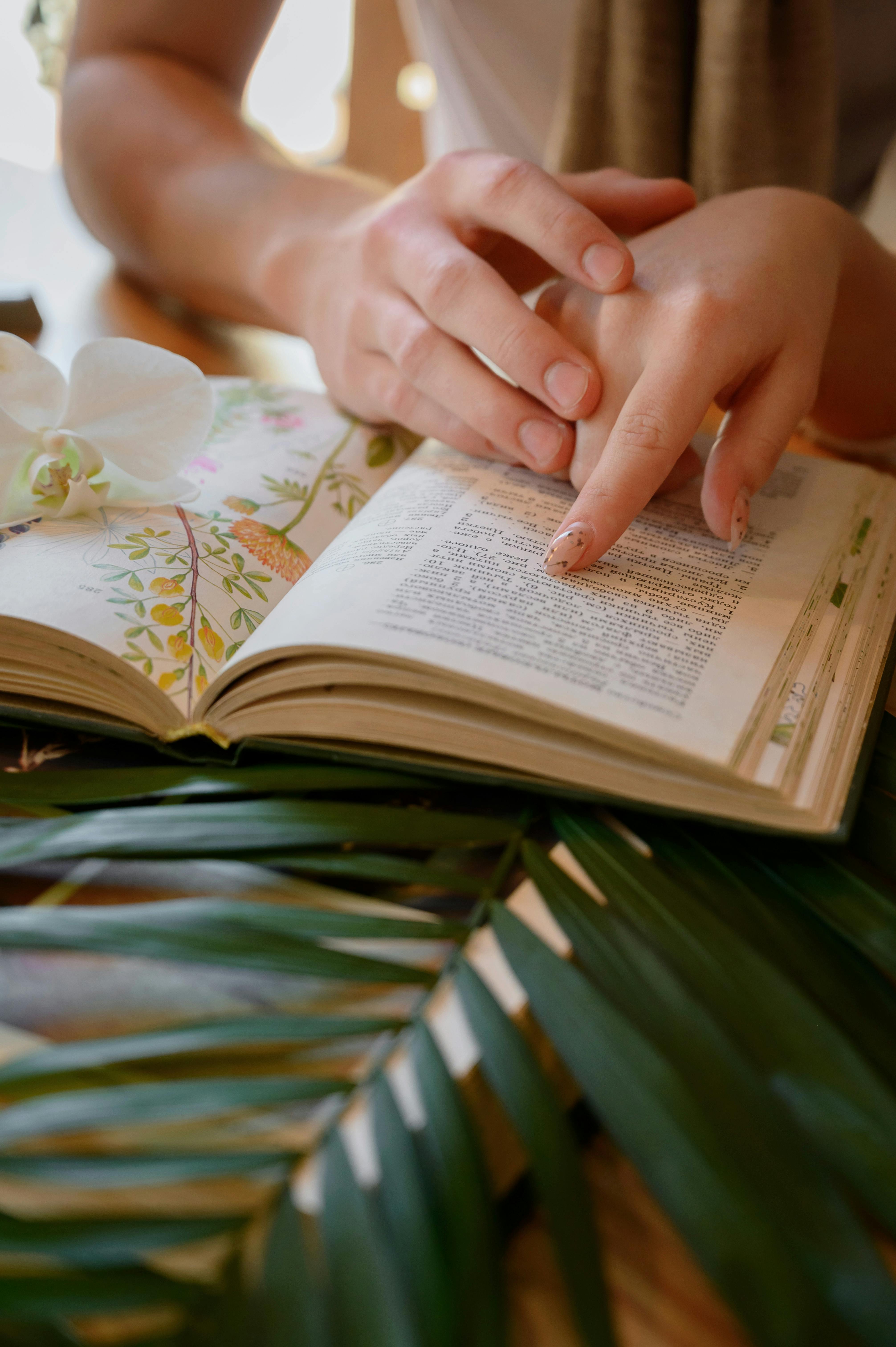 Two hands on a book | Source: Pexels