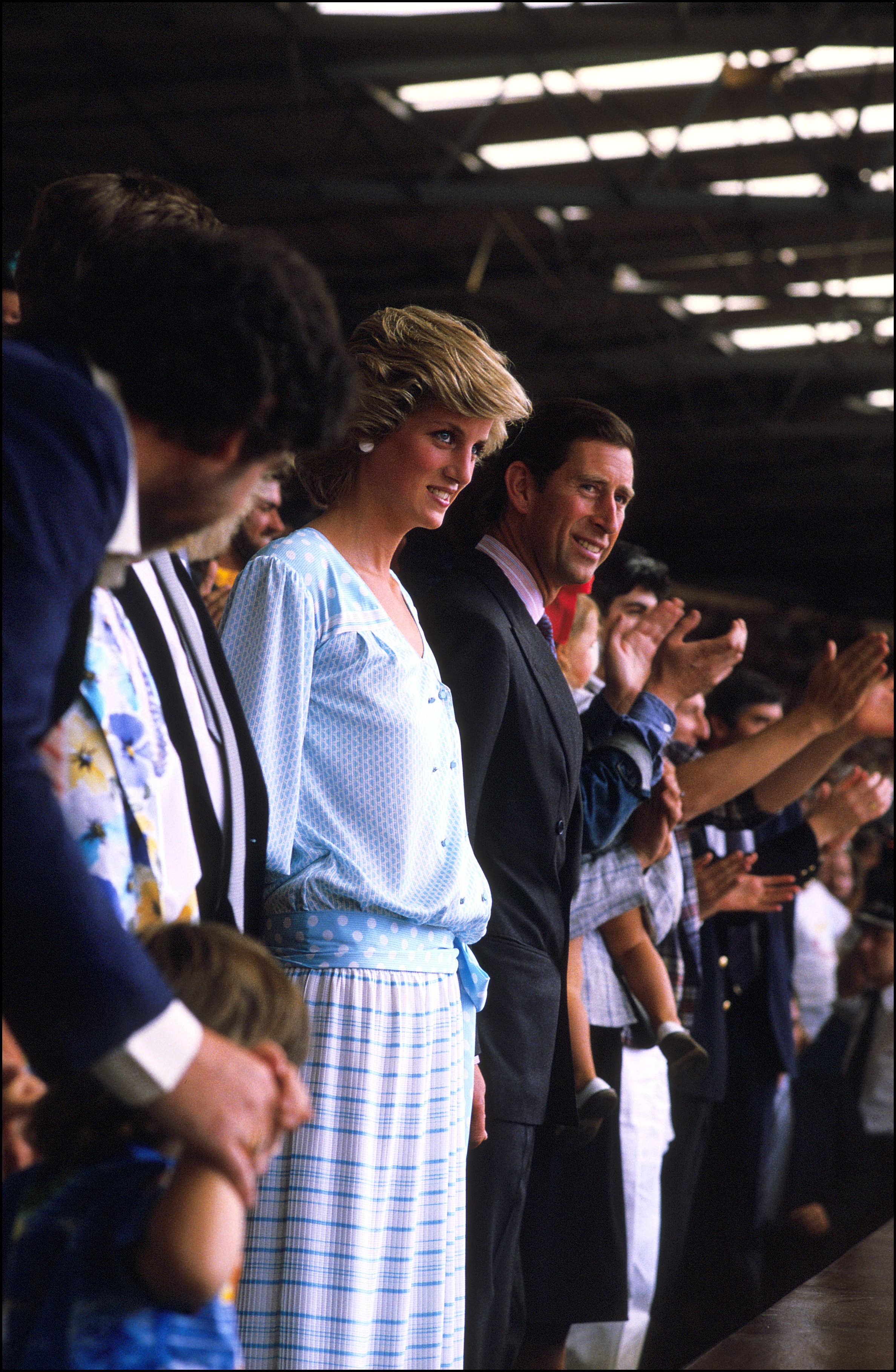 Prince Charles and Princess Diana, wearing a Kanga dress, at the Live Aid concert at Wembley Stadium on July 13, 1985 in London, England | Source: Getty Images