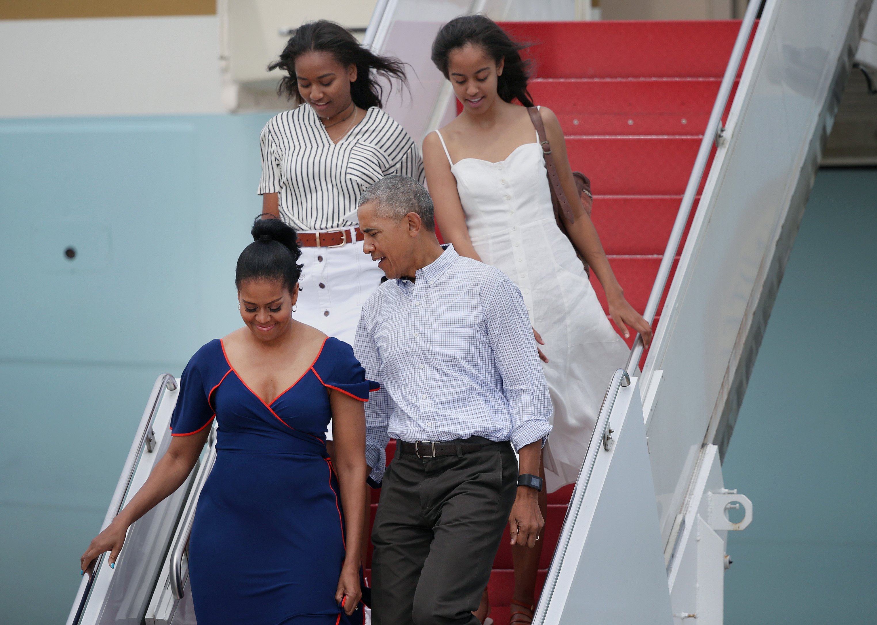 Barack Obama, First Lady Michelle Obama, and their daughters, Sasha and Malia, step off Air Force One at Joint Base Cape Cod to take Marine One to Martha's Vineyard for a vacation, August 6, 2016. | Source: Getty Images
