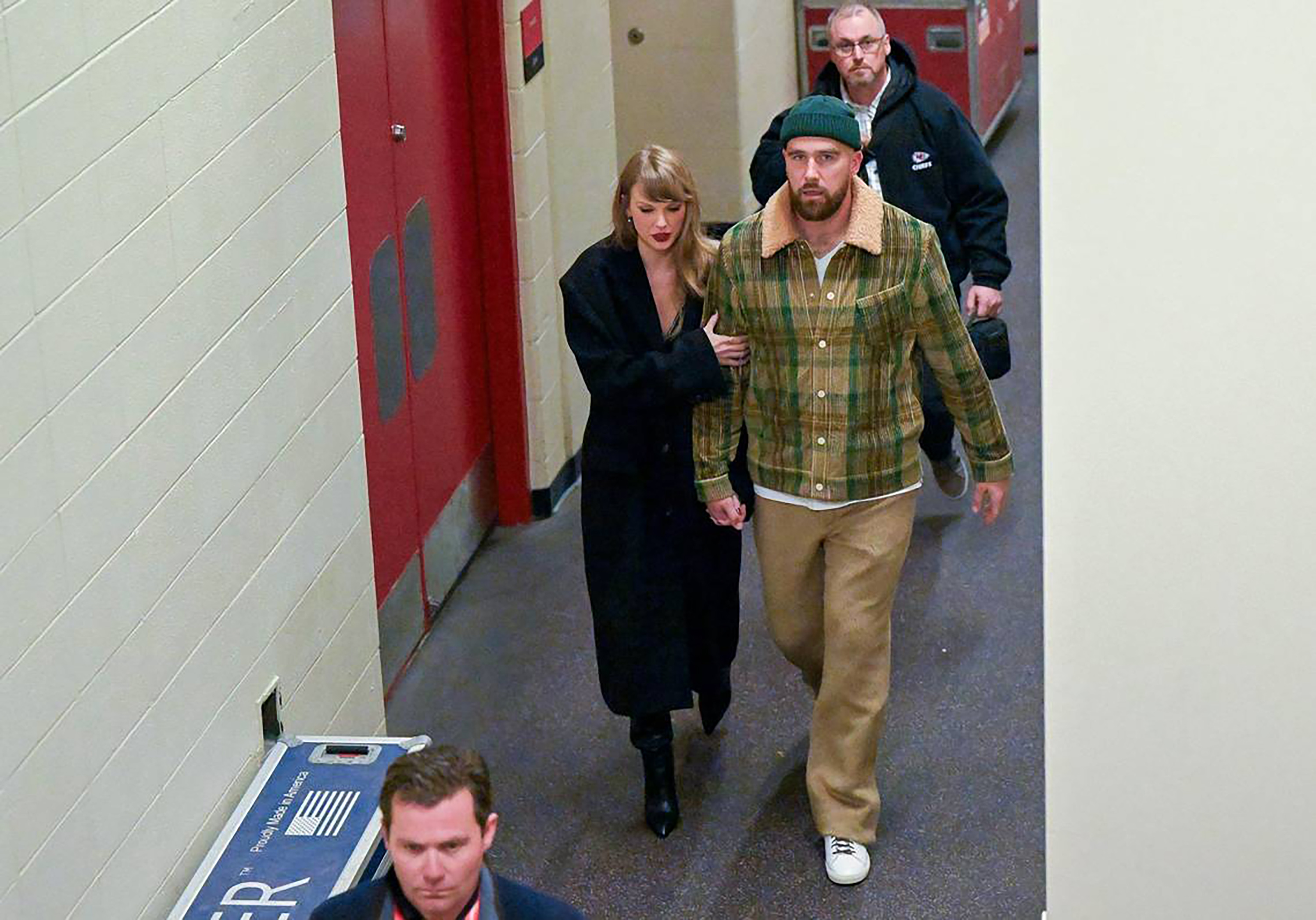 Taylor Swift walks arm in arm with Travis Kelce as they leave GEHA Field at Arrowhead Stadium after the Kansas City Chiefs' 20-17 loss to the Buffalo Bills on December 10, 2023, in Kansas City, Missouri.