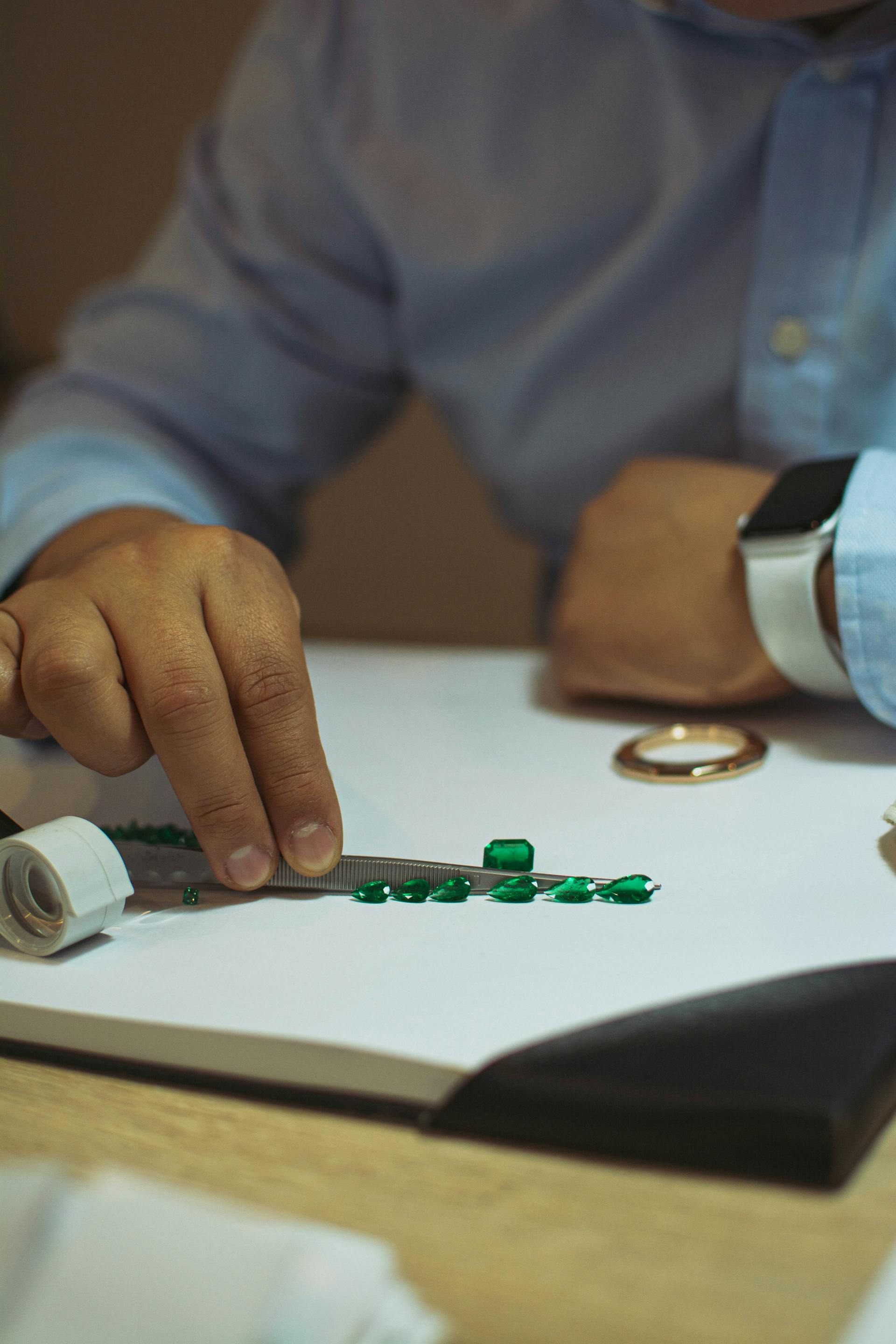 Person looking at emerald stones | Source: Pexels
