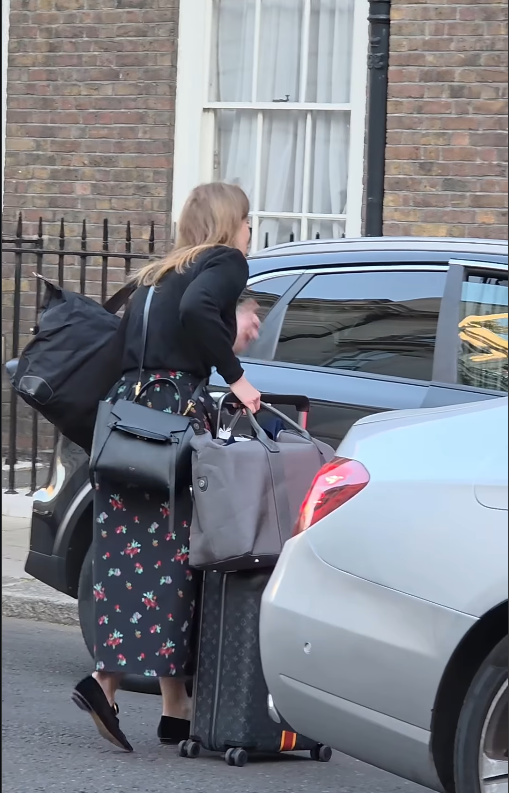 Princess Beatrice leans forward toward the driver to confirm her ride | Source: Instagram/kingsguardchannel