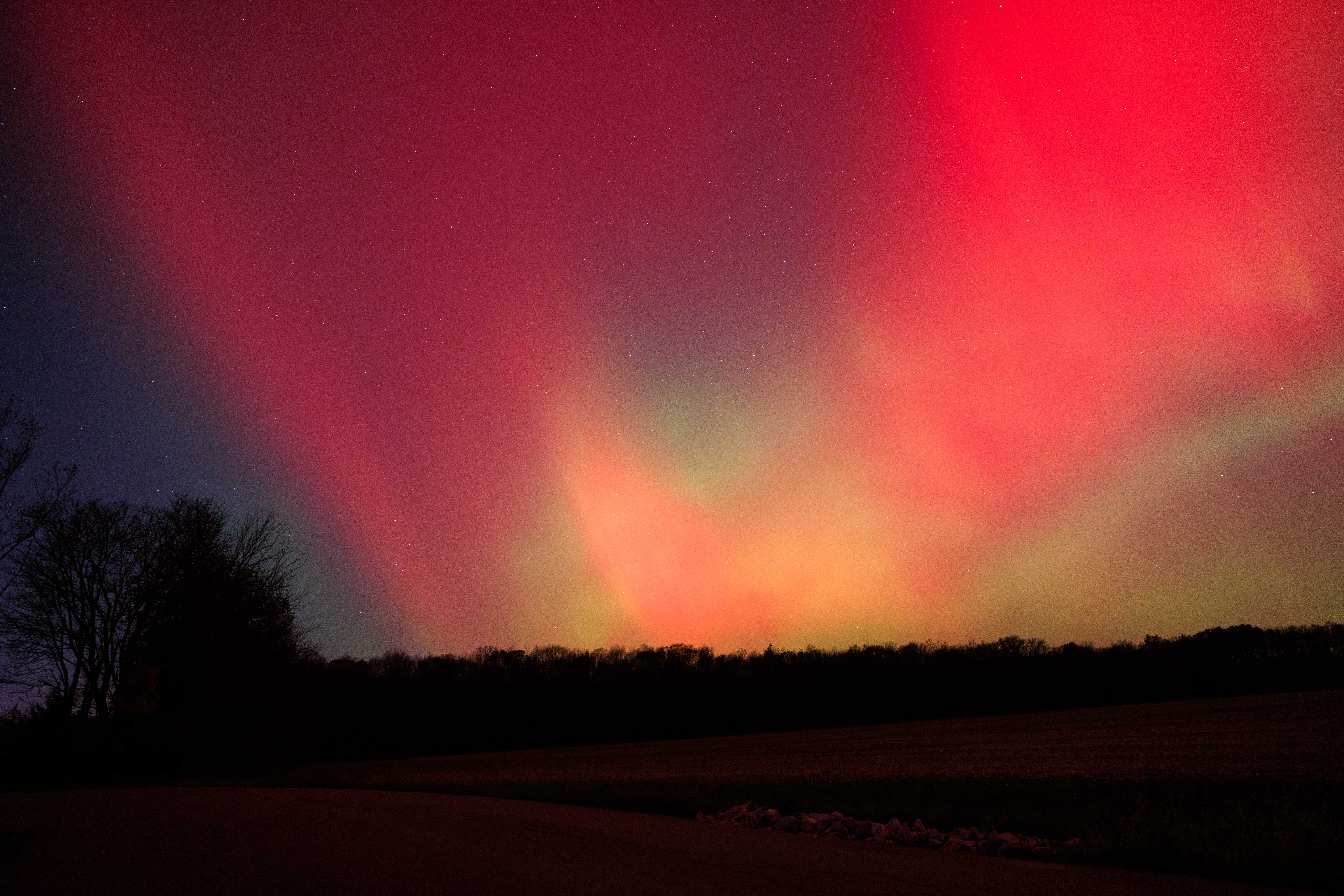The aurora borealis glows above rural Monroe County as a strong geomagnetic storm from recent solar activity pushes the Northern Lights unusually far south on November 12, 2025, in Bloomington, Indiana | Source: Getty Images