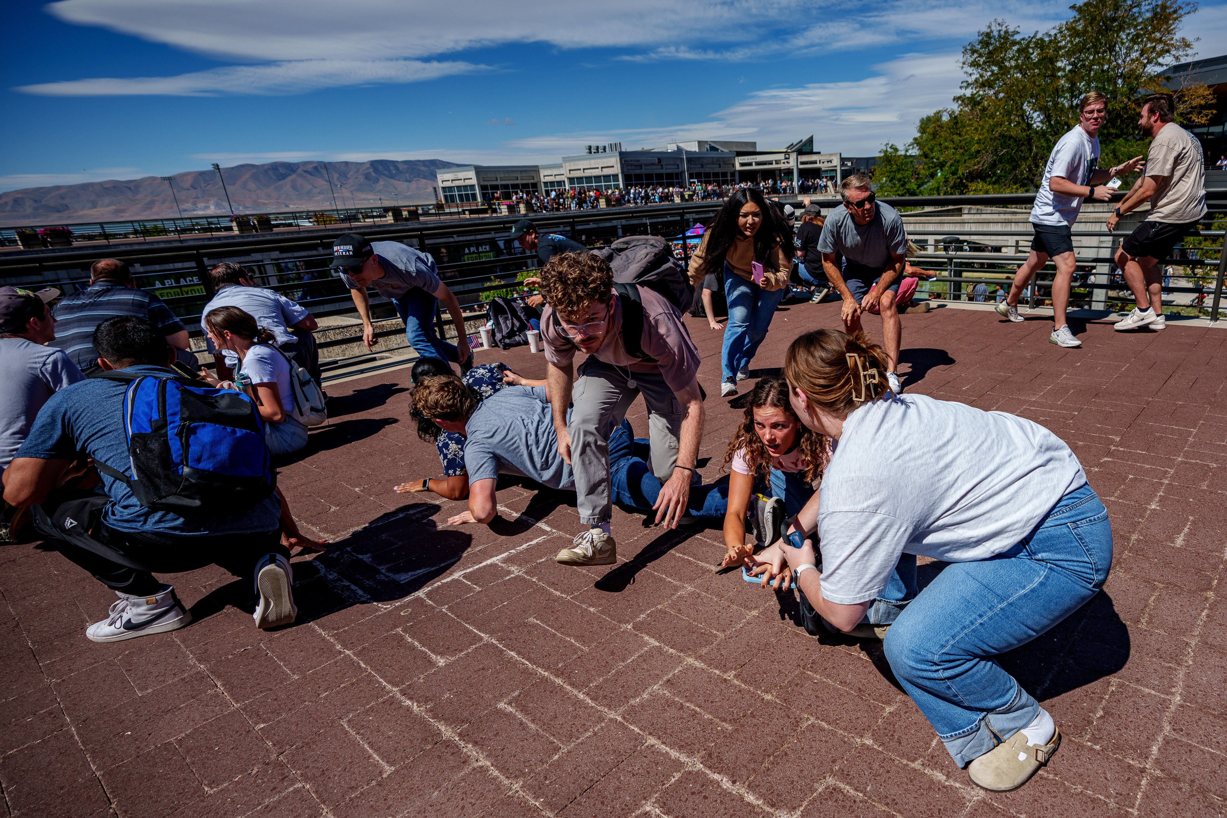 People scramble for safety after shots were fired during Charlie Kirk's appearance at Utah Valley University on September 10, 2025 | Source: Getty Images