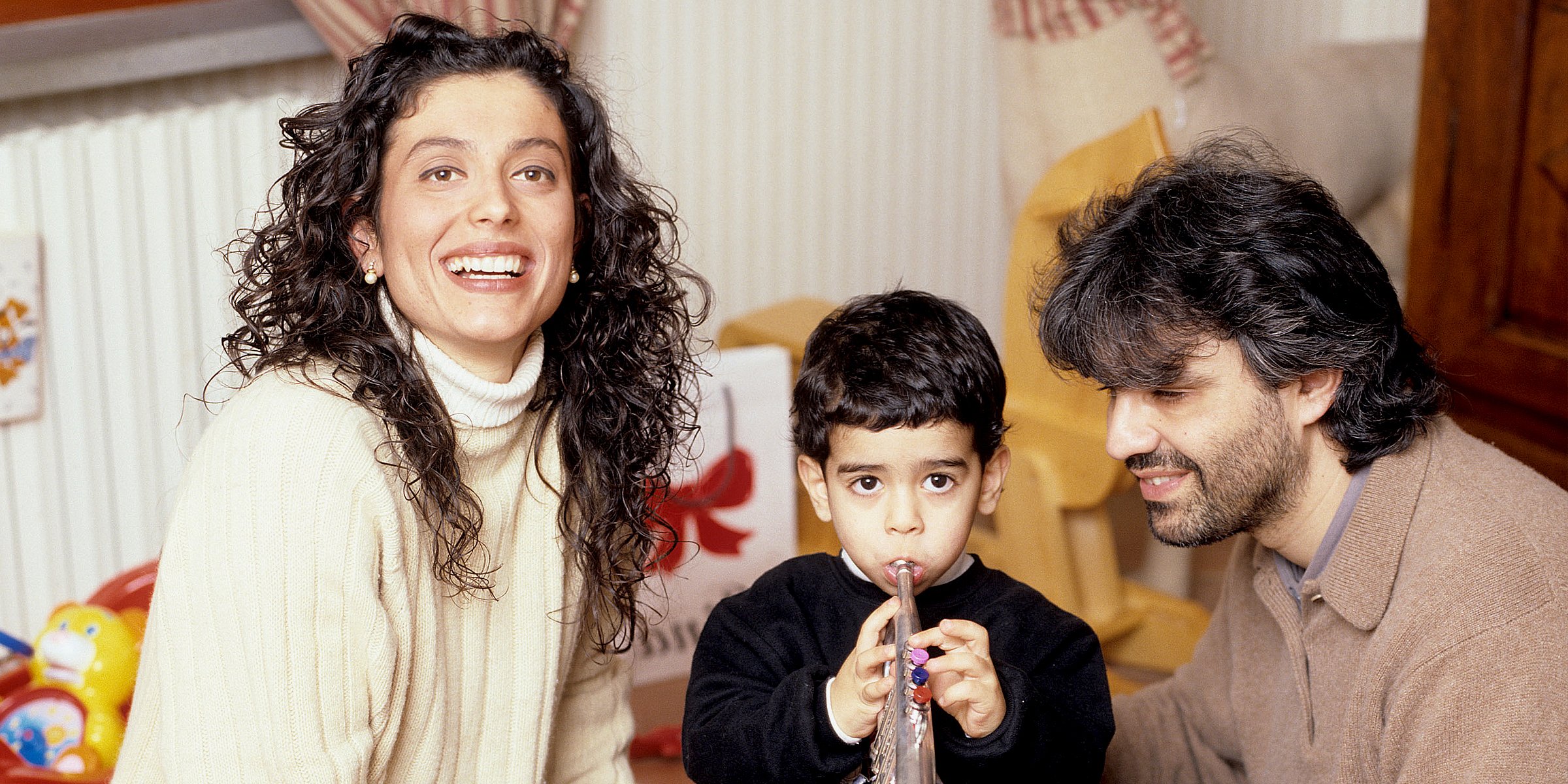 Andrea Bocelli at the piano with his wife Enrica Cenzatti and their son Amos.  The Italian tenor Andrea Bocelli seated at the …