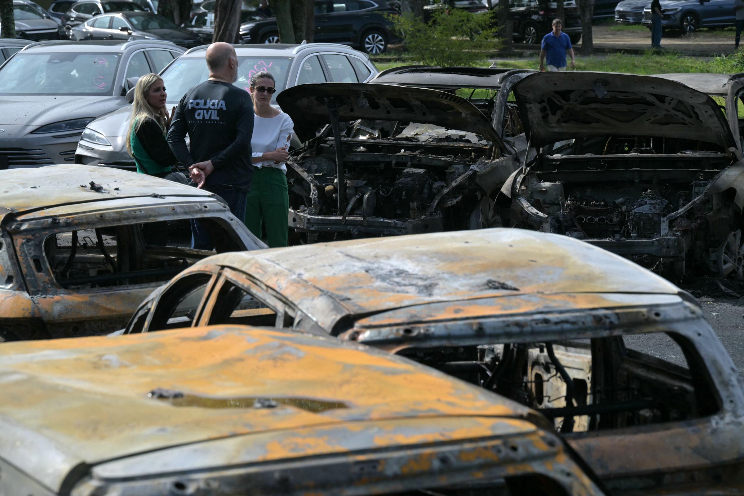 Investigators examined burned cars at the crash site after one of the helicopters crashed into a storage yard in Rio de Janeiro. | Source: Getty Images