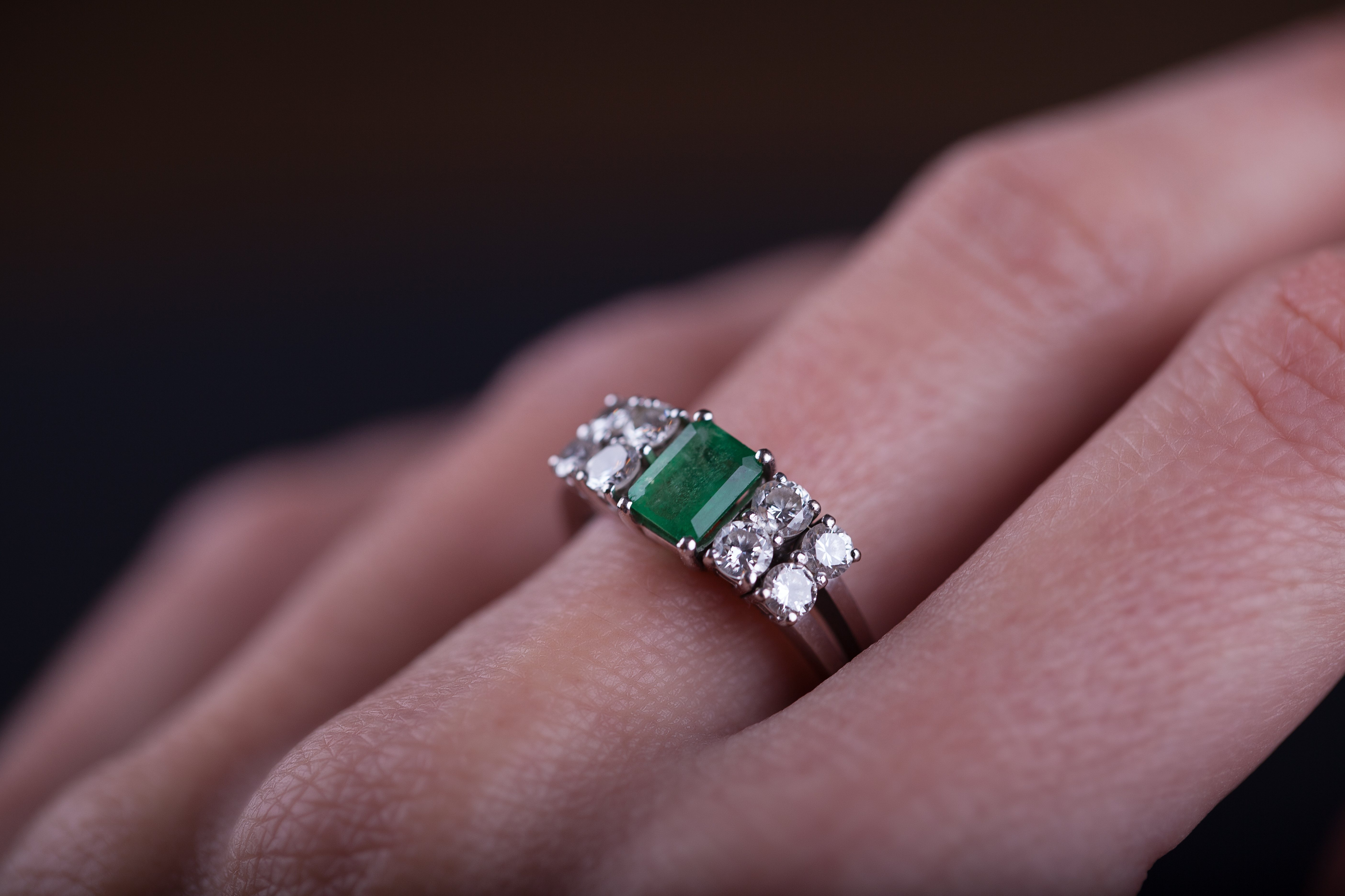 Emerald and diamond ring in finger | Source: Getty Images