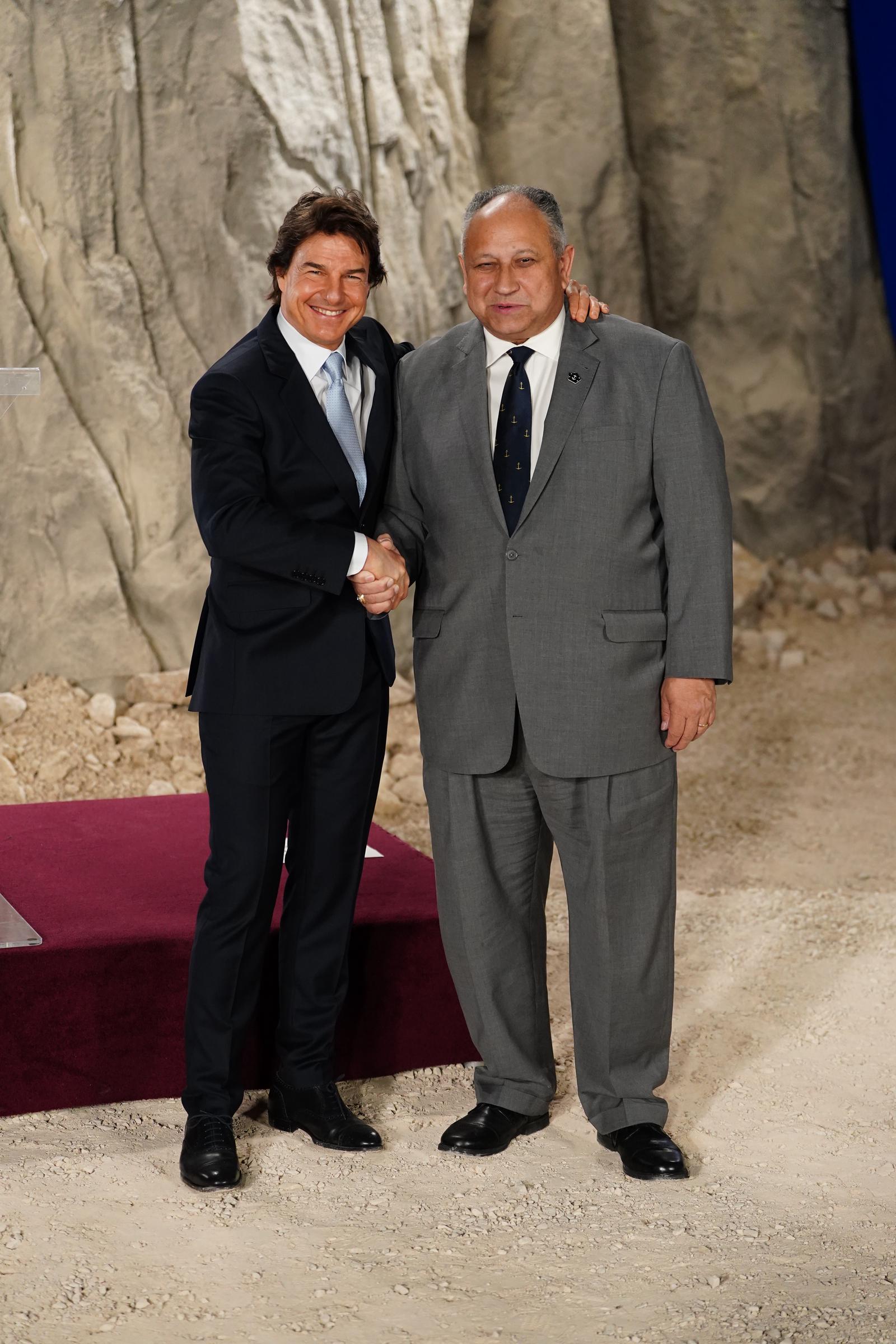 Tom Cruise and US Secretary of the Navy, Carlos Del Toro at Long Cross, UK, on December 17, 2024 | Source: Getty Images