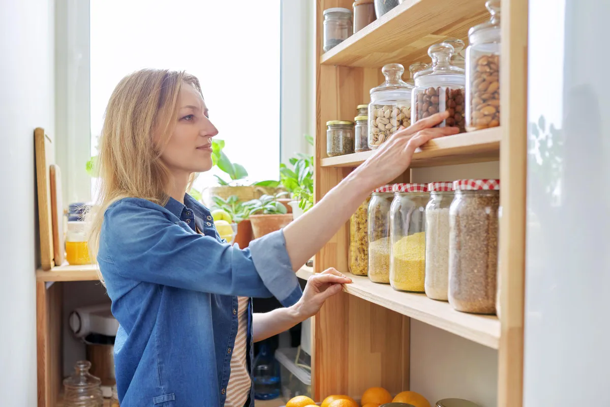 Woman fixing her pantry | Source: Shutterstock